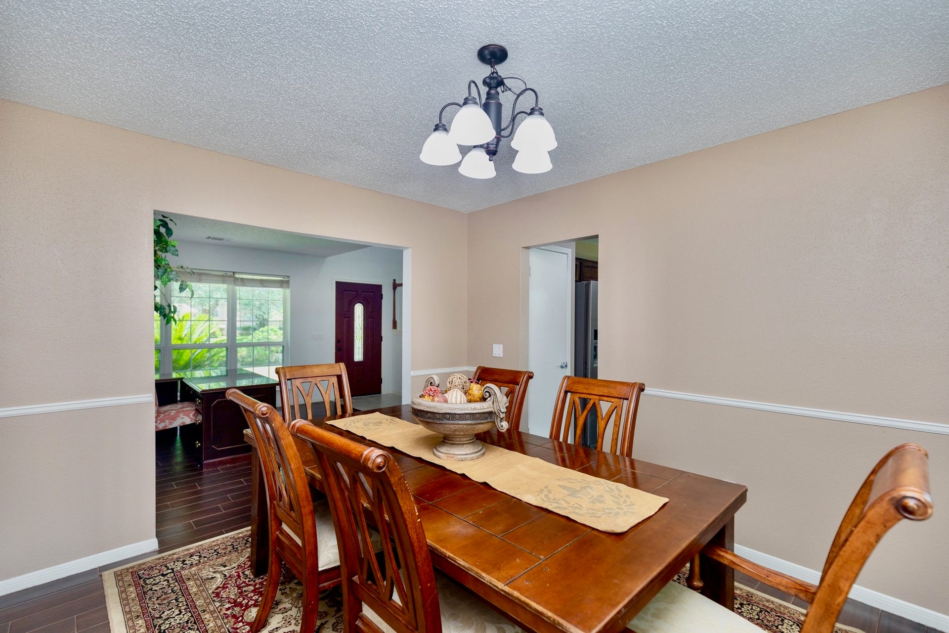 3007 Rimrock Drive, Missouri City, TX 77459 JUST OFF THE KITCHEN, THE FORMAL DINING ROOM IS GRANDFEATURING WAINSCOATING DETAIL AND OFFERING SCENIC VIEWS OF THE GROUNDS!!!