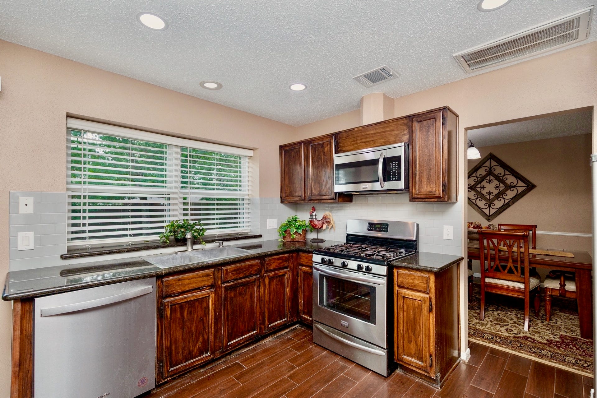 3007 Rimrock Drive, Missouri City, TX 77459 FARMHOUSE INSPIRED, THE KITCHEN FEATURES BEAUTIFUL GRANITE COUNTERTOPS, ENDLESS HARDWOOD CABINETRY, AND STAINLESS APPLIANCES!!!