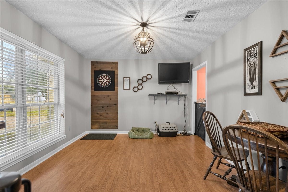 214 Oakwood Street, League City, TX 77573 Additional dining area view featuring a large front-facing window and natural light.