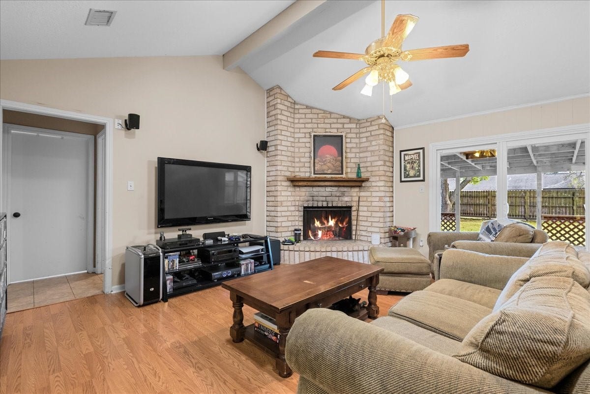 214 Oakwood Street, League City, TX 77573 Additional living room view highlighting the brick fireplace and comfortable seating area.