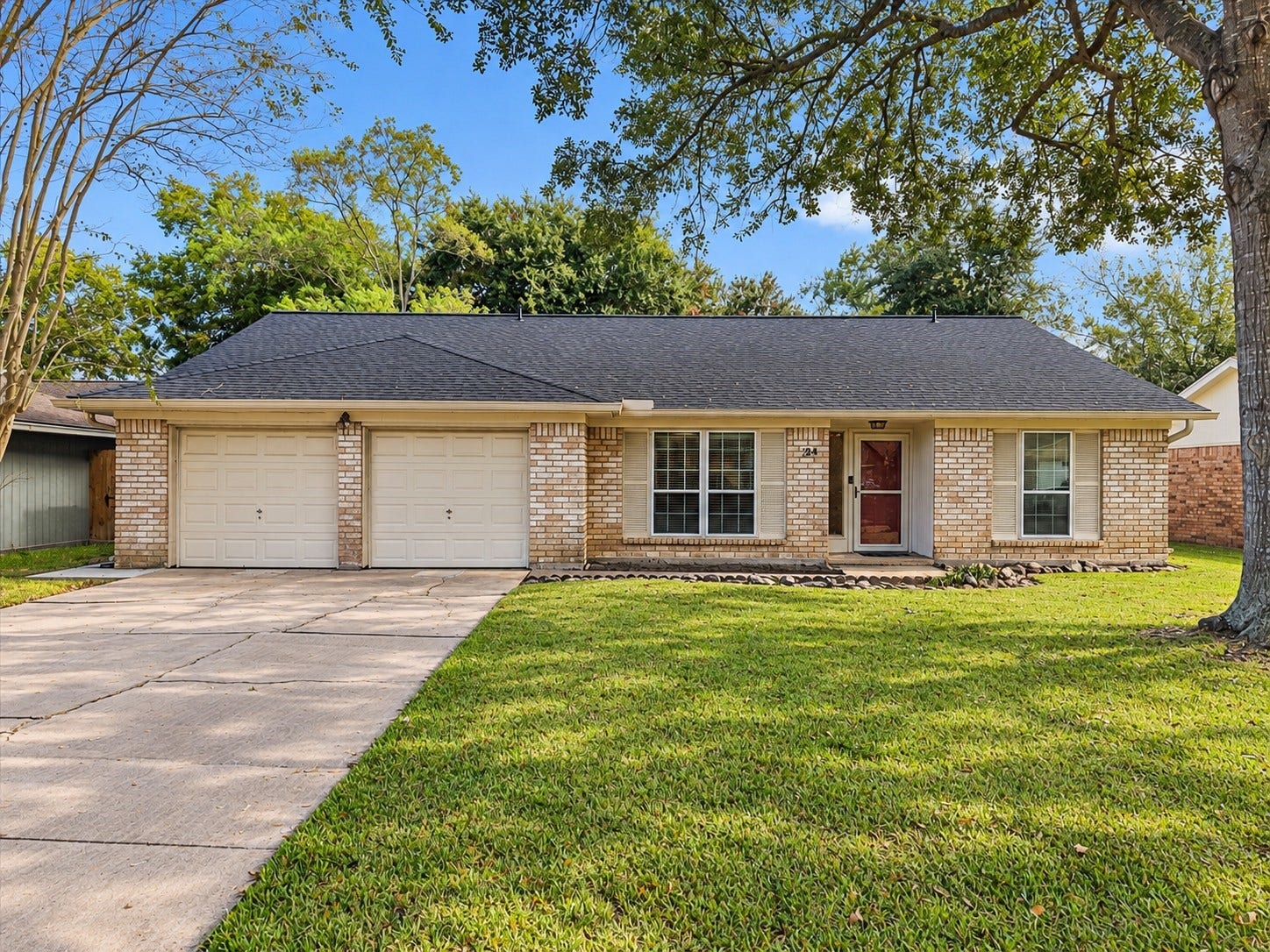 214 Oakwood Street, League City, TX 77573 Welcome to 214 Oakwood St! Single-story brick home with mature shade trees and an attached two-car garage.