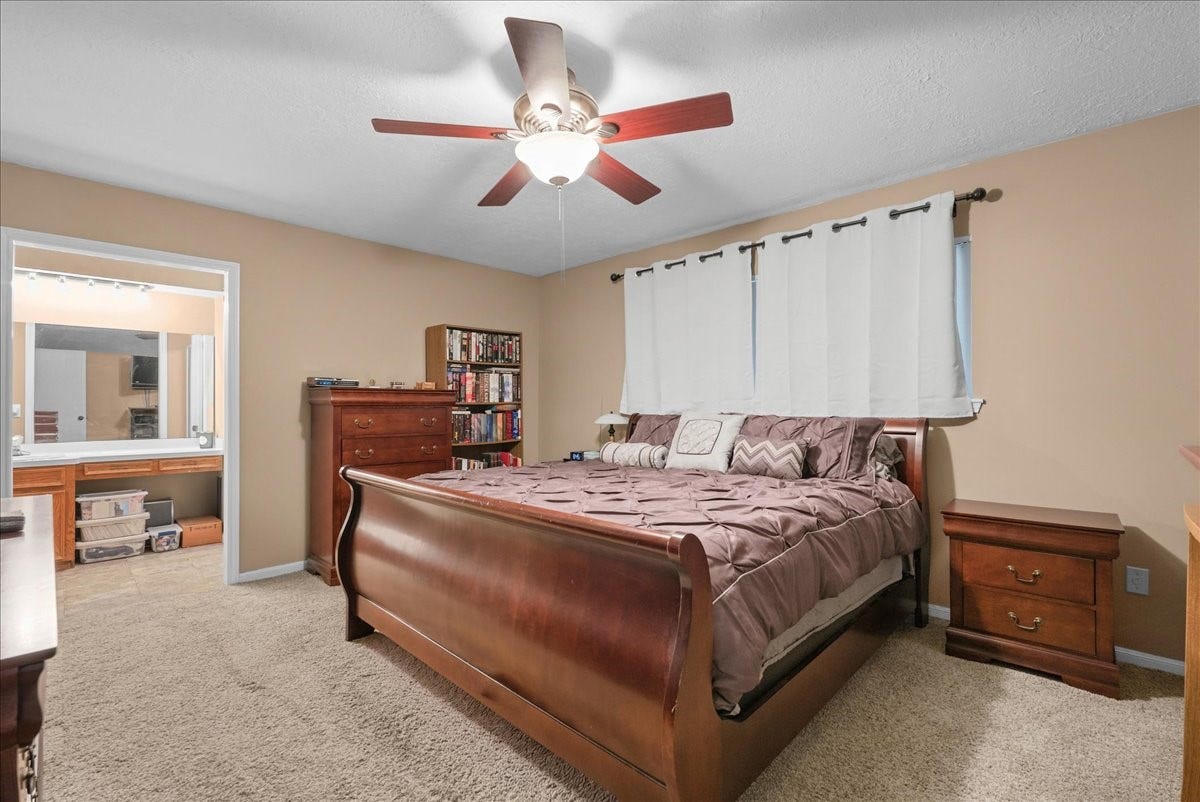 214 Oakwood Street, League City, TX 77573 Primary bedroom offers generous space for furniture and convenient access to the ensuite bathroom.