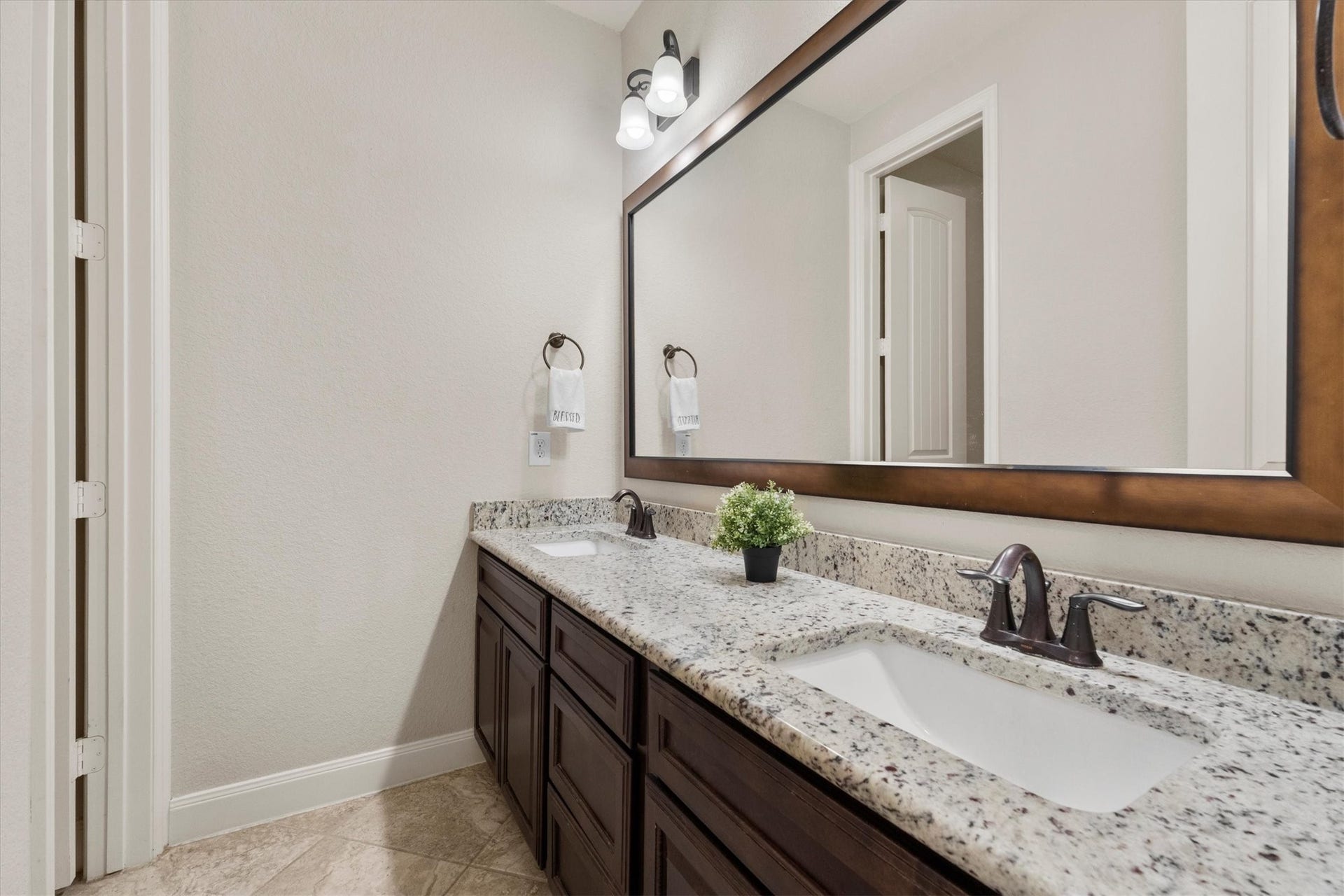 17903 Fernwood Bend Drive, Tomball, TX 77377 A double bowl granite topped vanity provides plenty of cabinet and drawer storage.