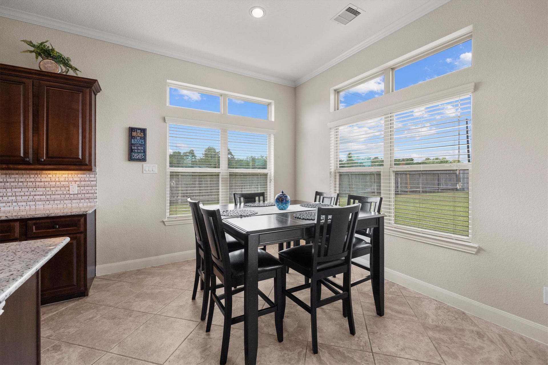 17903 Fernwood Bend Drive, Tomball, TX 77377 Meals are always better at the table. The Breakfast Area overlooks the back and side yards through these beautiful windows dressed in blinds, topped with transoms.