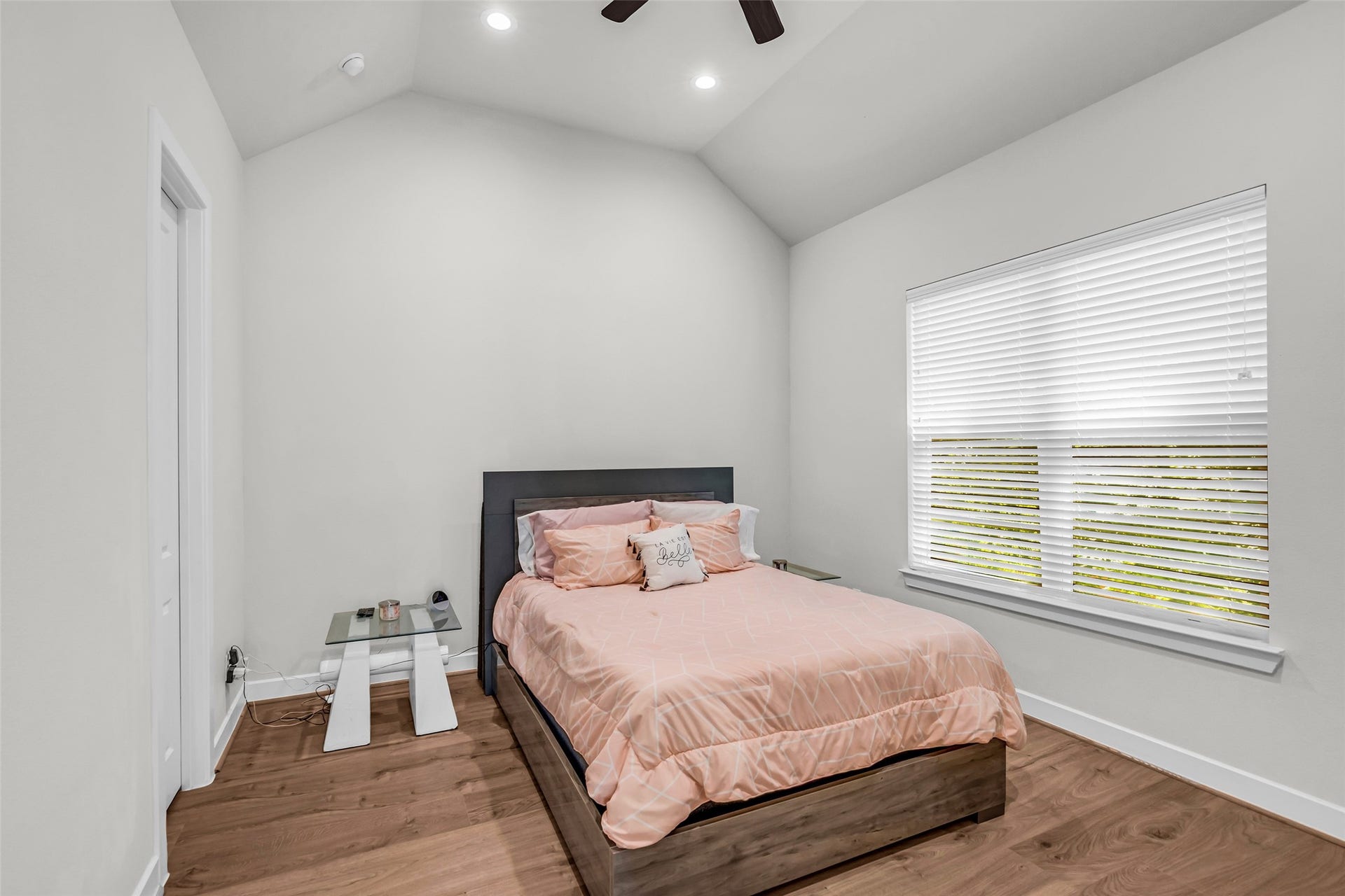 3313 Hutchins Street, Houston, TX 77004 Primary bedroom located on the second floor, featuring wood flooring and a large window with views of the backyard, bringing in natural light and a comfortable atmosphere.