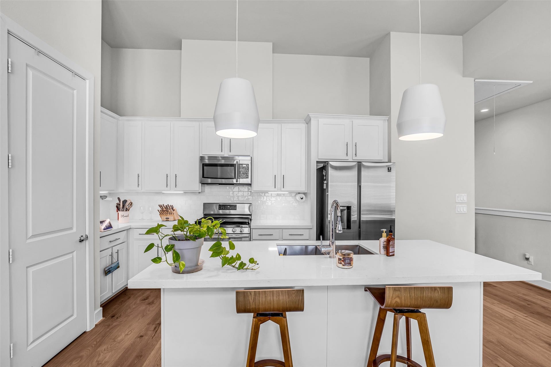 3313 Hutchins Street, Houston, TX 77004 Full view of the kitchen showcasing the layout of the appliances and workspace. The closed door leads to a pantry, providing convenient storage for groceries and kitchen essentials.
