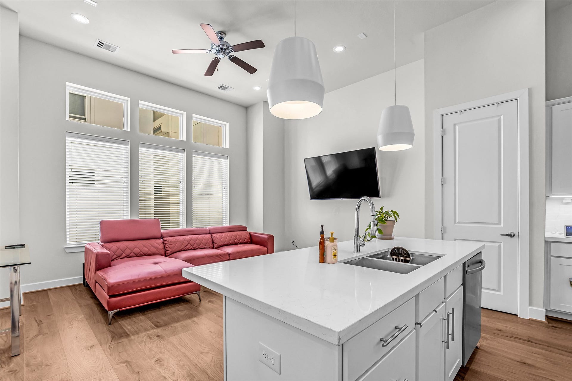 3313 Hutchins Street, Houston, TX 77004 The kitchen, dining area, and living room are filled with natural light coming through large windows along the living room wall, creating a bright and welcoming shared space.