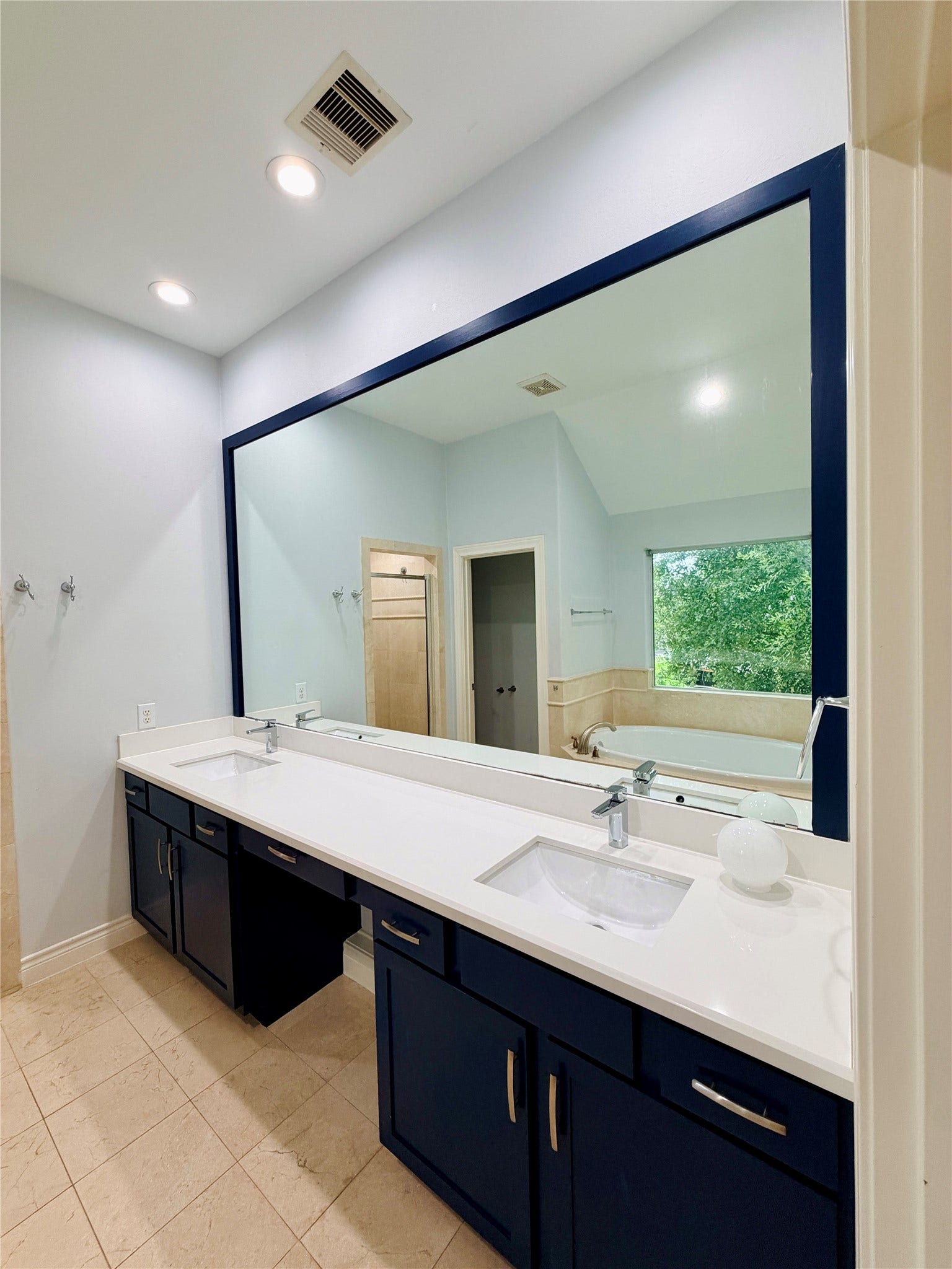3526 Cline Street, Houston, TX 77020 The oversized dual-sink vanity features sleek quartz countertops, modern fixtures, abundant cabinet storage, and a full-width framed mirror.