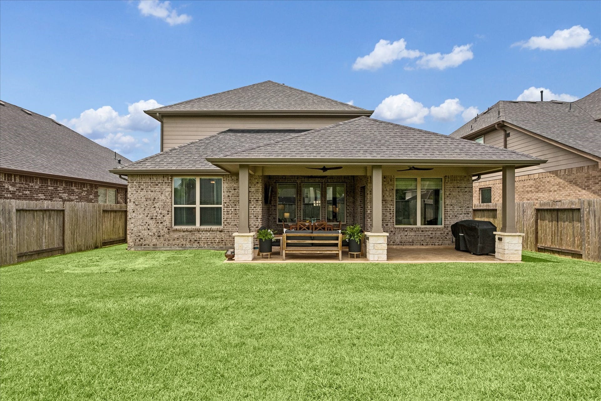 1520 Harvest Vine Court, Friendswood, TX 77546 Back elevation of the house with back patio addition with ample room to relax, entertain and play.