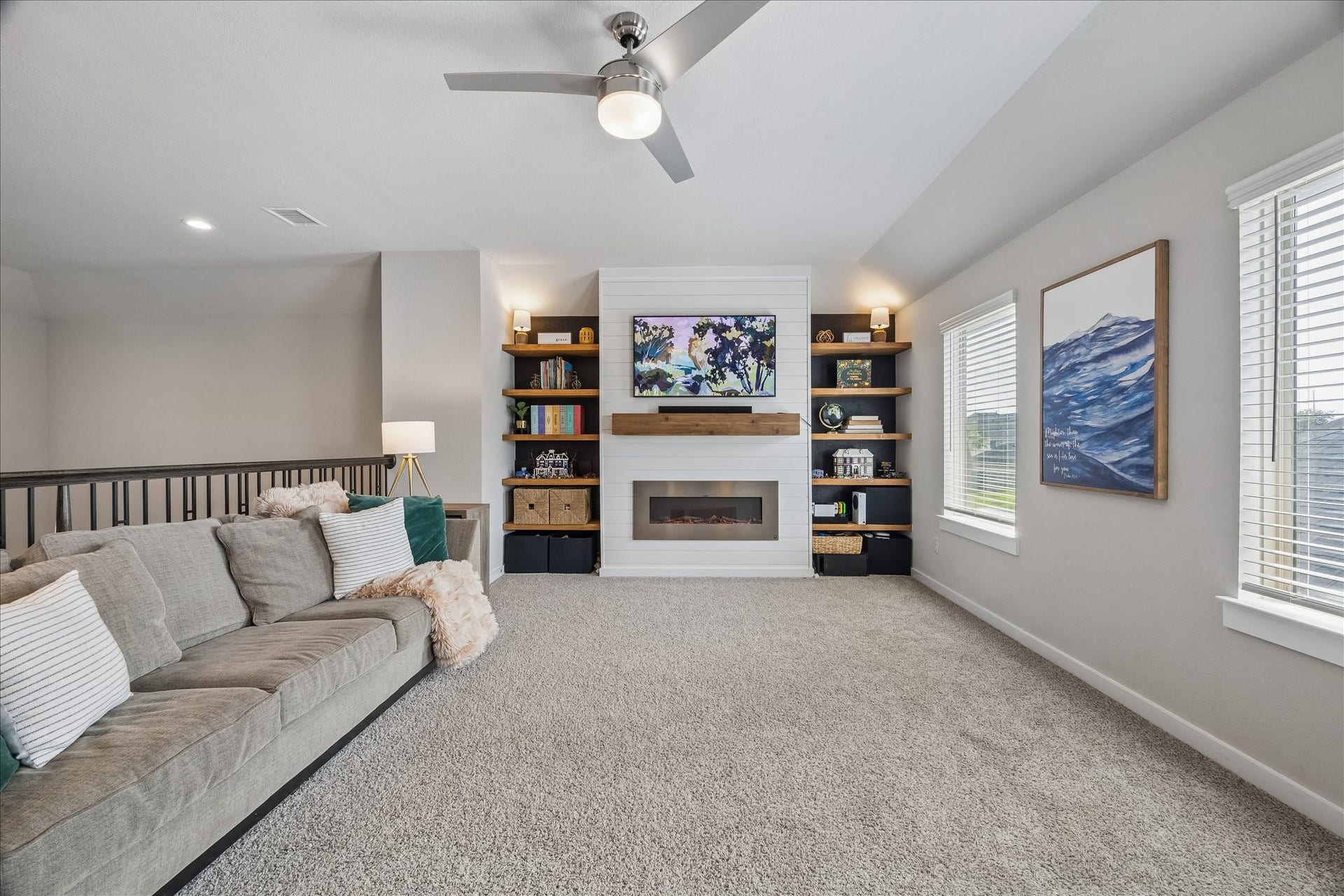 1520 Harvest Vine Court, Friendswood, TX 77546 Must See! Open game room overlooking the living area below, enhanced with custom built-ins, a shiplap fireplace, and a mantel for warm, inviting gathering space.