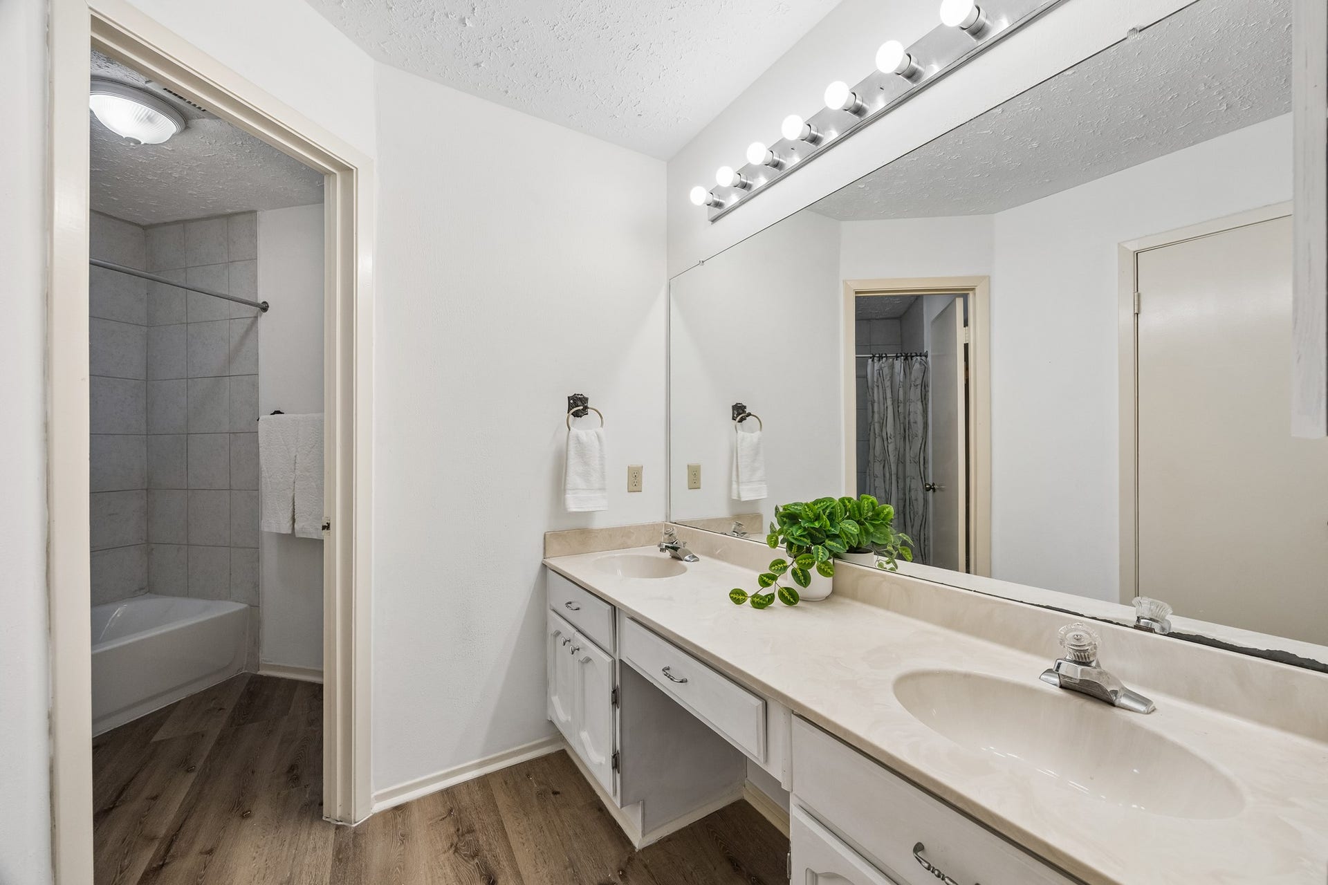 2319 Hampton Road, League City, TX 77573 Primary ensuite bathroom provides LVP in wet spaces, double sinks, and Hollywood lighting.