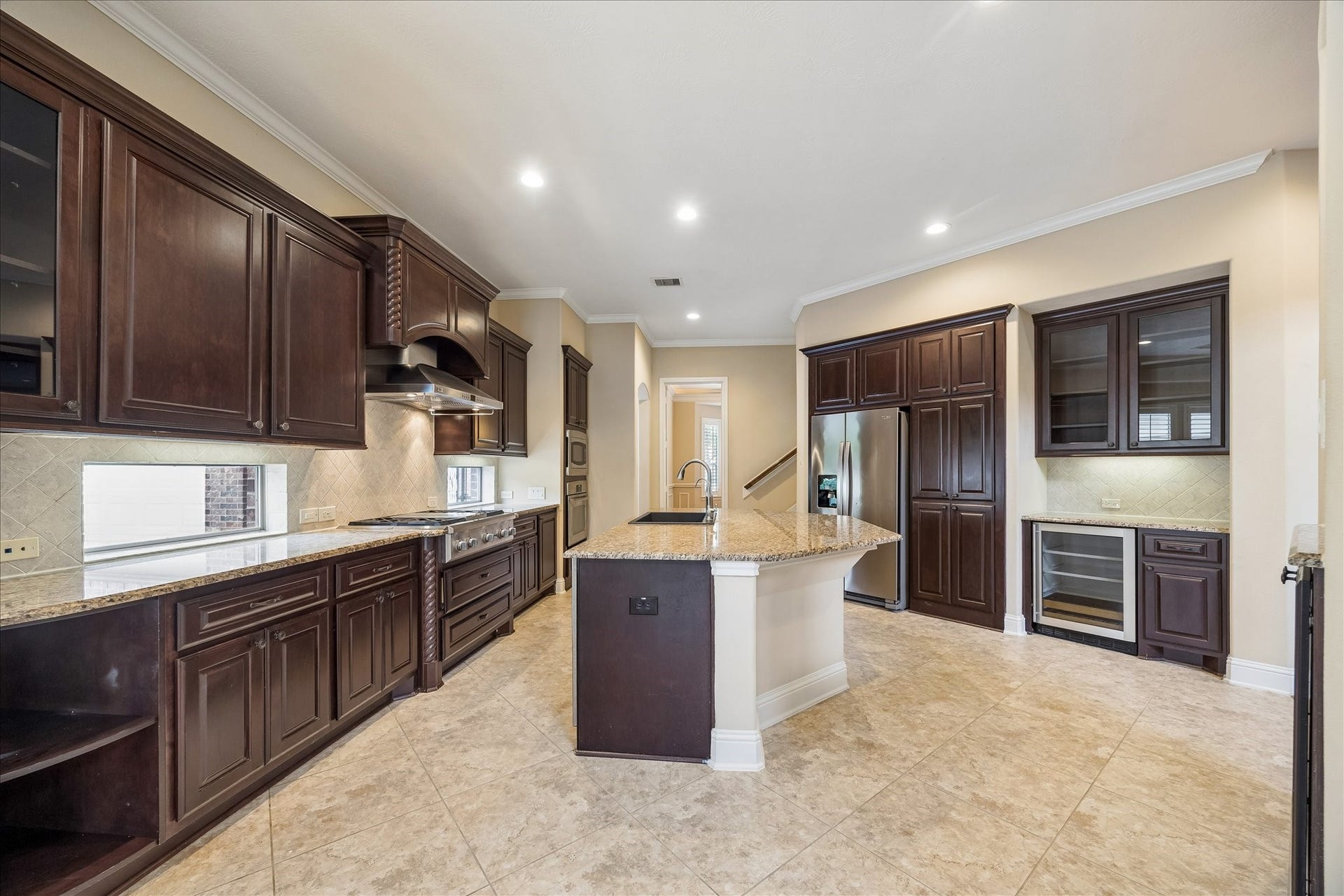 4506 Beacon View Court, Sugar Land, TX 77479 In addition to the abundant cabinetry, the kitchen features a separate beverage refrigerator and the perfect spot for a wine/coffee bar.