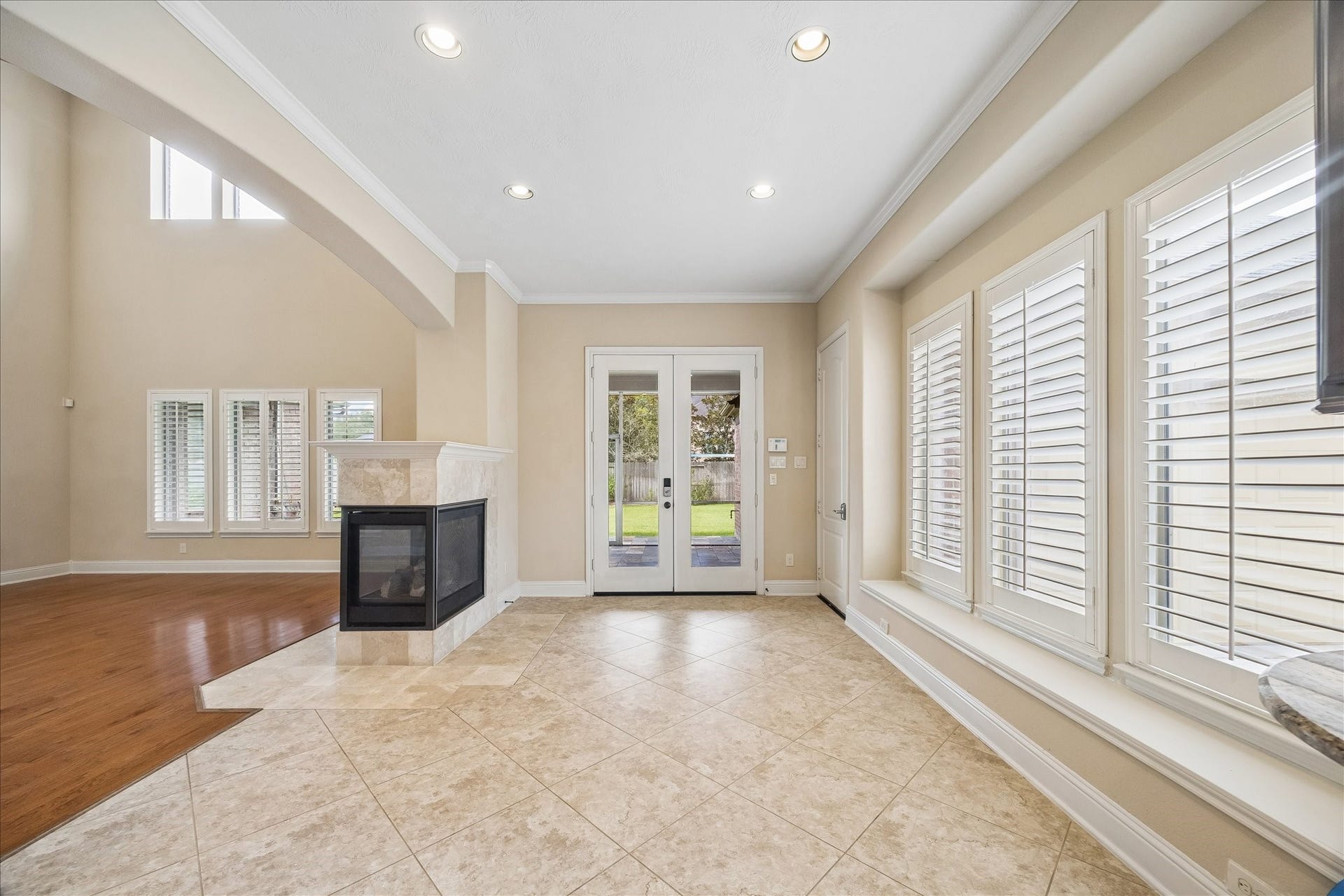 4506 Beacon View Court, Sugar Land, TX 77479 The peninsula fireplace is shared between casual dining and the family room. The double French doors lead onto the screened-in porch.