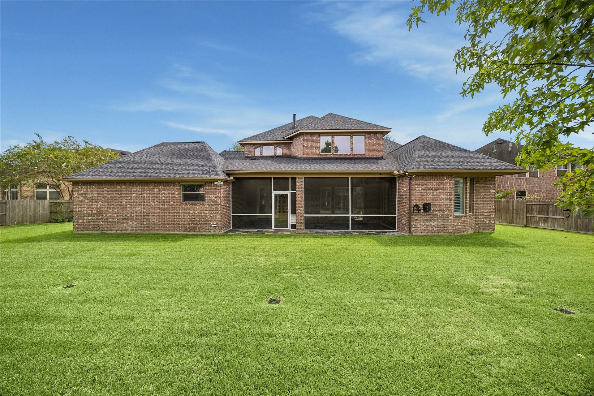 4506 Beacon View Court, Sugar Land, TX 77479 The homes covered and screened patio provides a comfortable transition between indoor and outdoor living, while mature trees and a fully fenced yard offer privacy and a peaceful setting.
