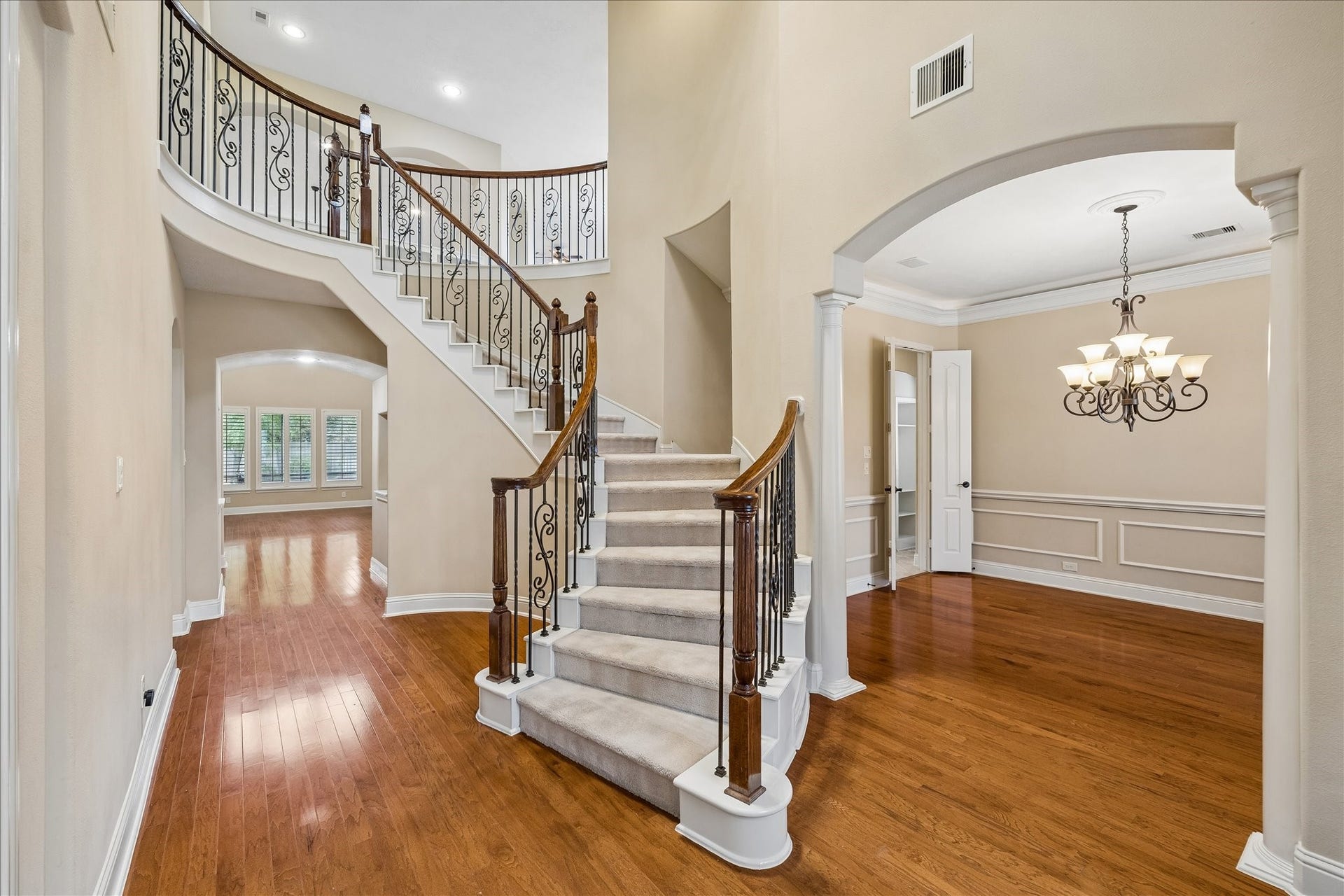 4506 Beacon View Court, Sugar Land, TX 77479 The grand staircase splits at the mid-way point to provide access to the foyer and the kitchen.