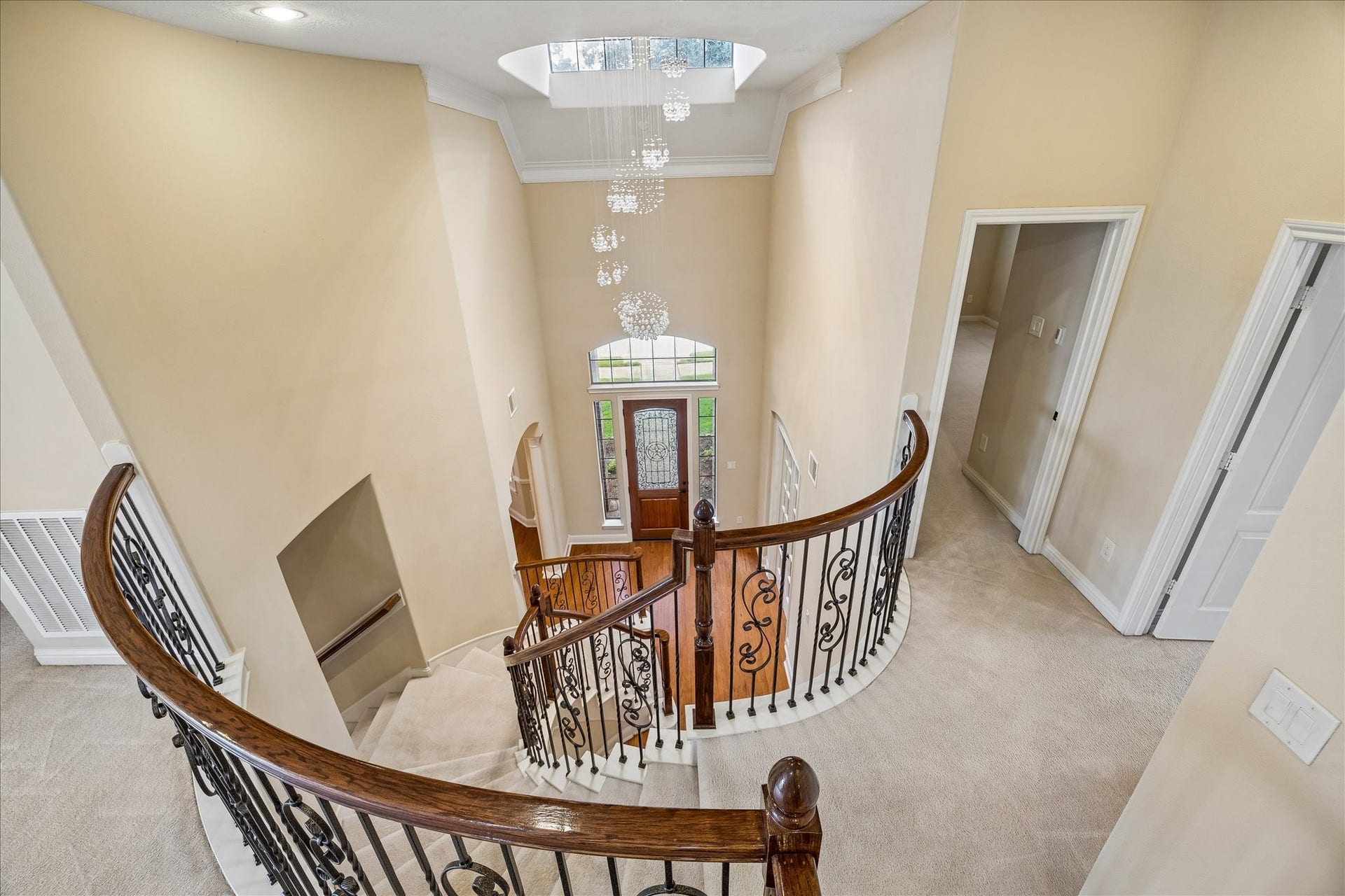 4506 Beacon View Court, Sugar Land, TX 77479 Striking grand staircase is split to offer access to both the kitchen and the foyer. A better view of the custom chandelier.