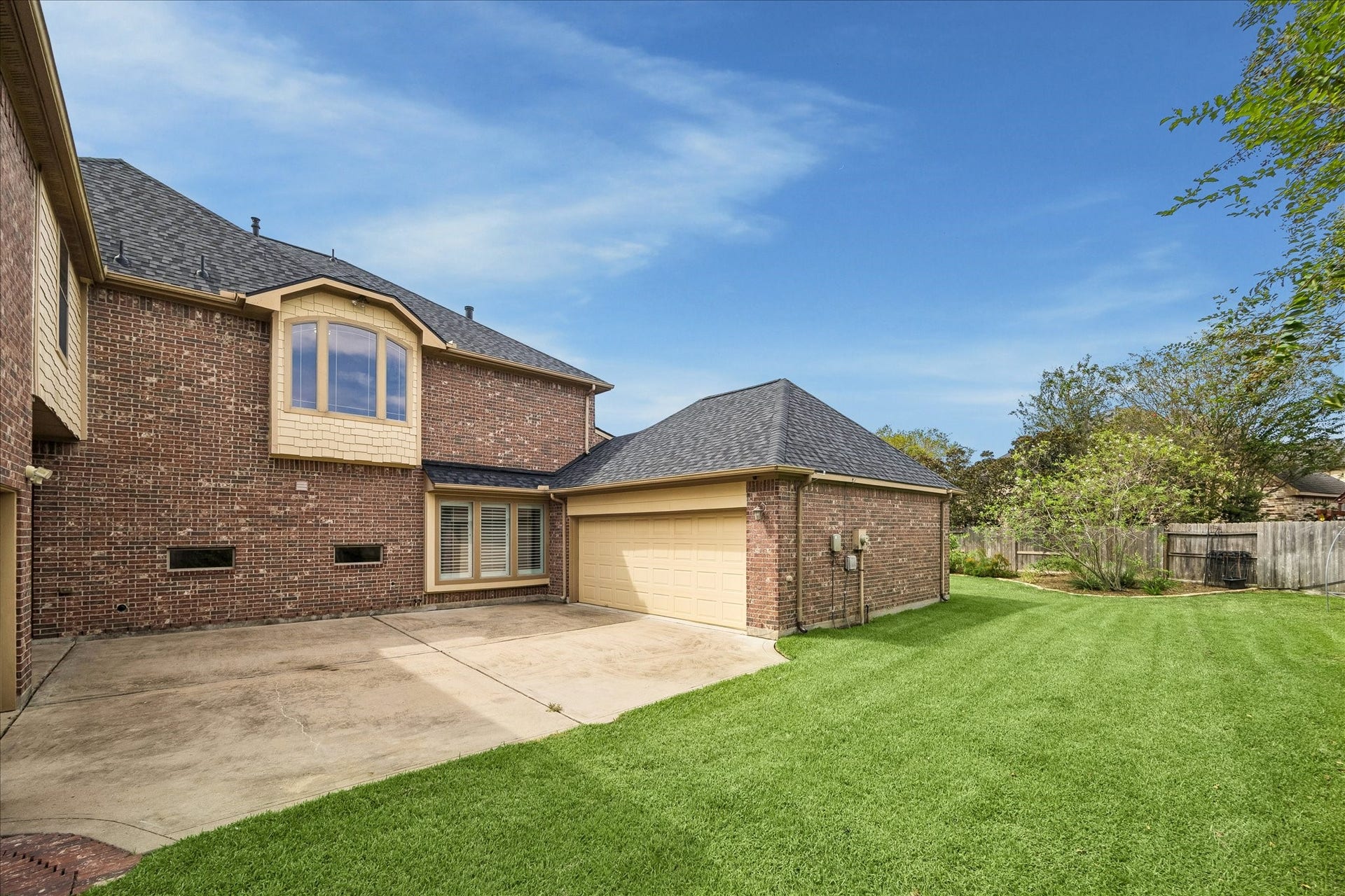 4506 Beacon View Court, Sugar Land, TX 77479 This private courtyard area is secured behind the driveway gate and provides access to both garages. This could be a great location for a basketball court. A Tesla charger is located inside the two-car garage. A tankless water heater and a water softener add to this home's many features.