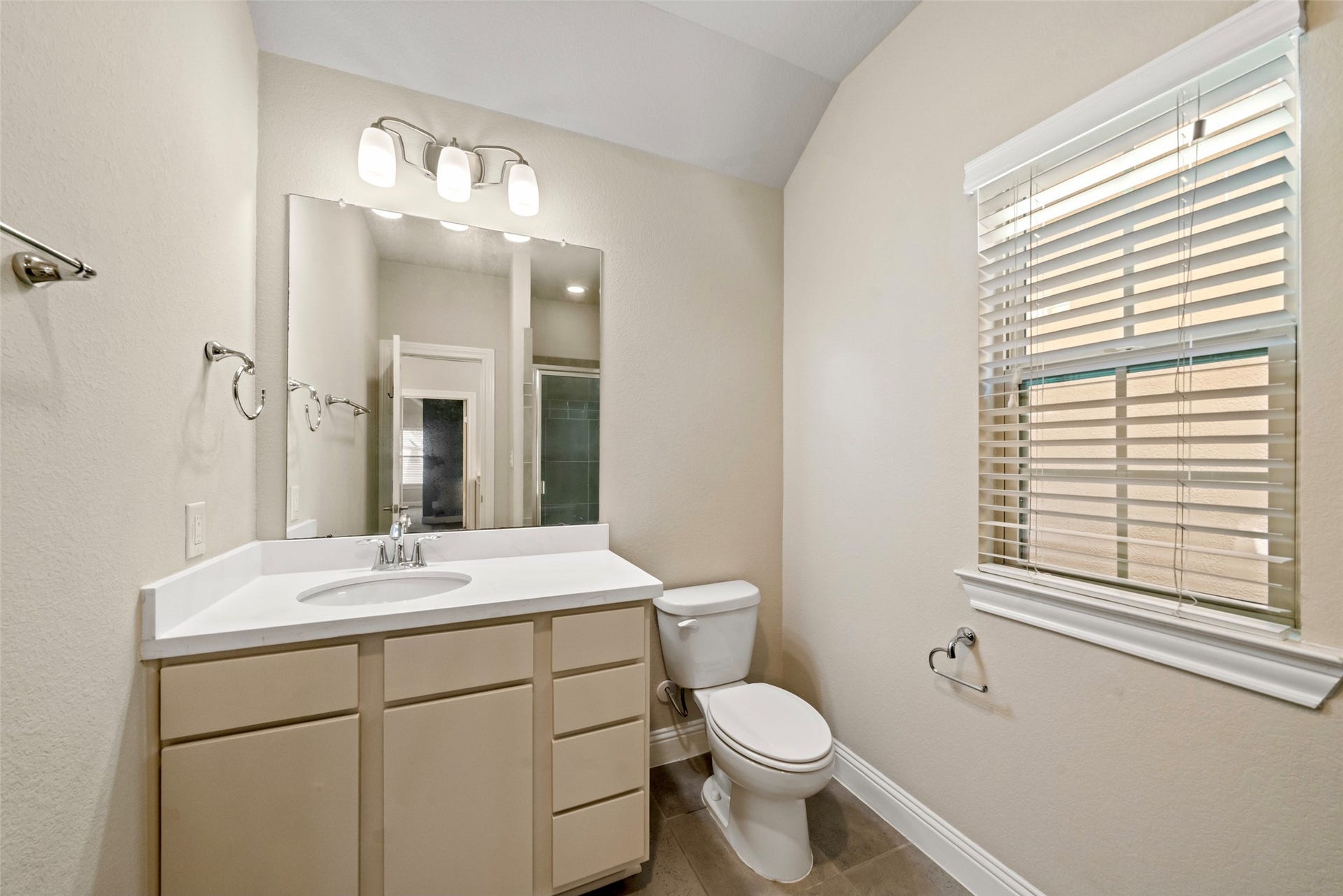 2627 Shady Woods Lane, Houston, TX 77008 The third floor bathroom is completely updated with cool tones, fixtures and features a standing shower.