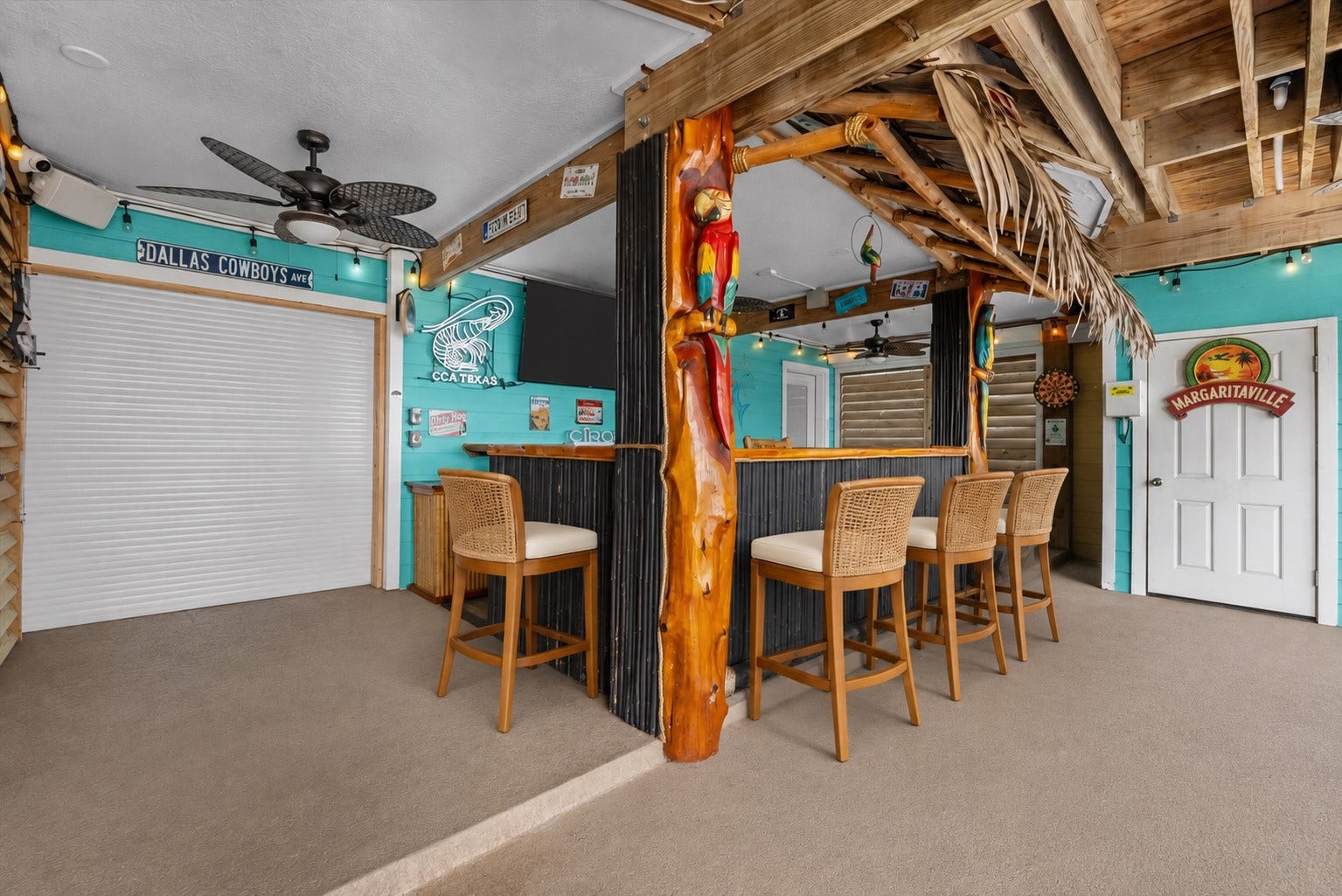 1331 EDWARDS DRIVE, Dickinson, TX 77539 COVERED TIKI BAR AREA WITH WRAPAROUND COUNTER SPACE, CEILING FANS, ROLL-DOWN SHUTTERS, AND DIRECT ACCESS TO THE OUTDOOR ENTERTAINING AREAS. **Virtually Staged.