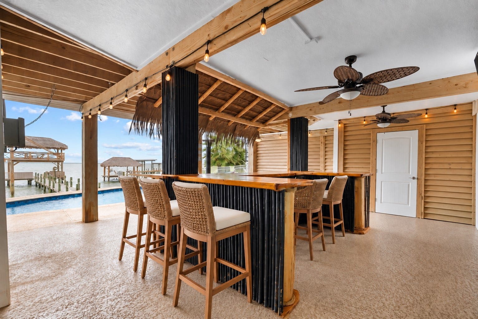 1331 EDWARDS DRIVE, Dickinson, TX 77539 COVERED TIKI BAR WITH WRAPAROUND COUNTER SPACE, CEILING FANS, ROLL-DOWN SHUTTERS, AND DIRECT ACCESS TO THE OUTDOOR ENTERTAINING AREAS.**Virtually Staged.