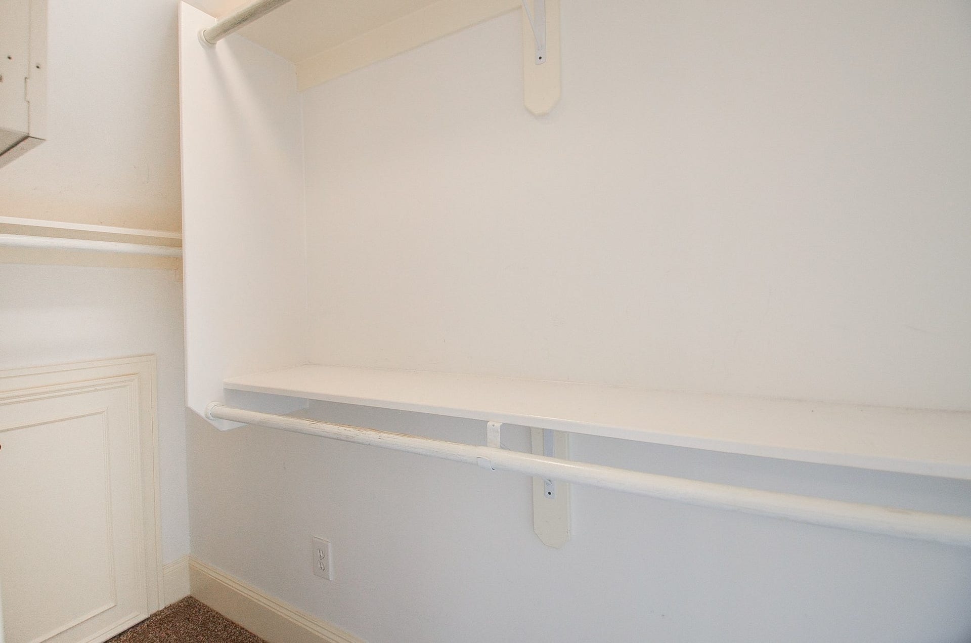 Spacious walk-in closet with ample shelving and hanging space for organized storage. There's also a hidden storage space in the closet. Great for out of season items or suitcases.