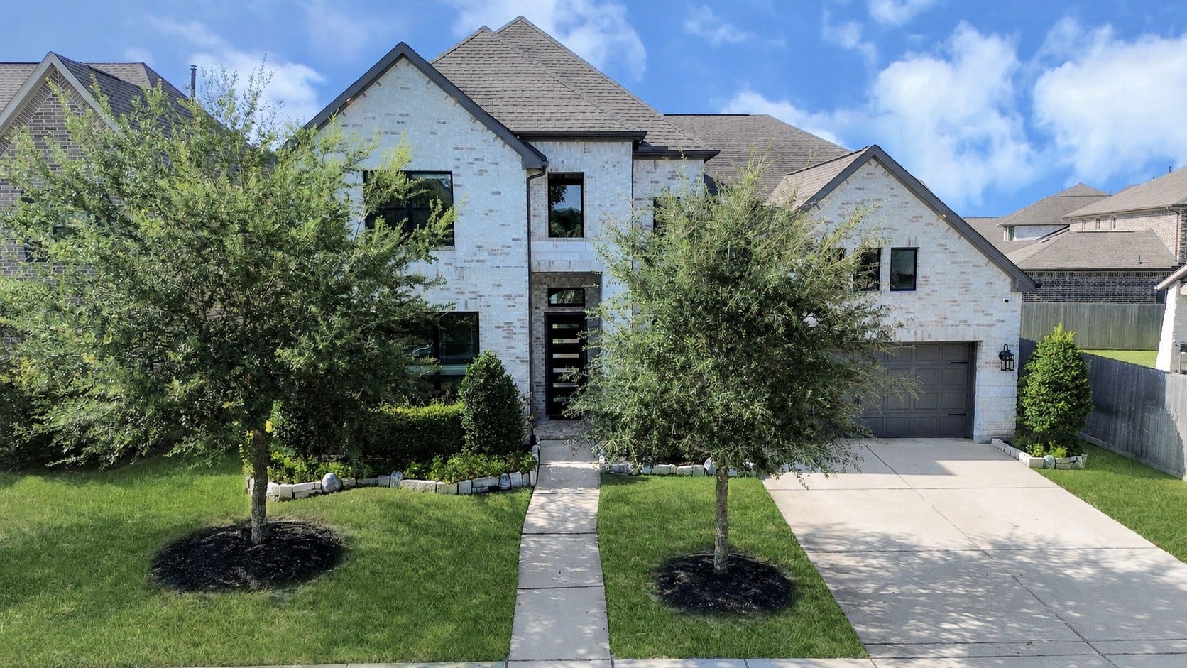 1423 Hackberry Heights Drive, Richmond, TX 77406 Charming two-story brick home with a spacious driveway.