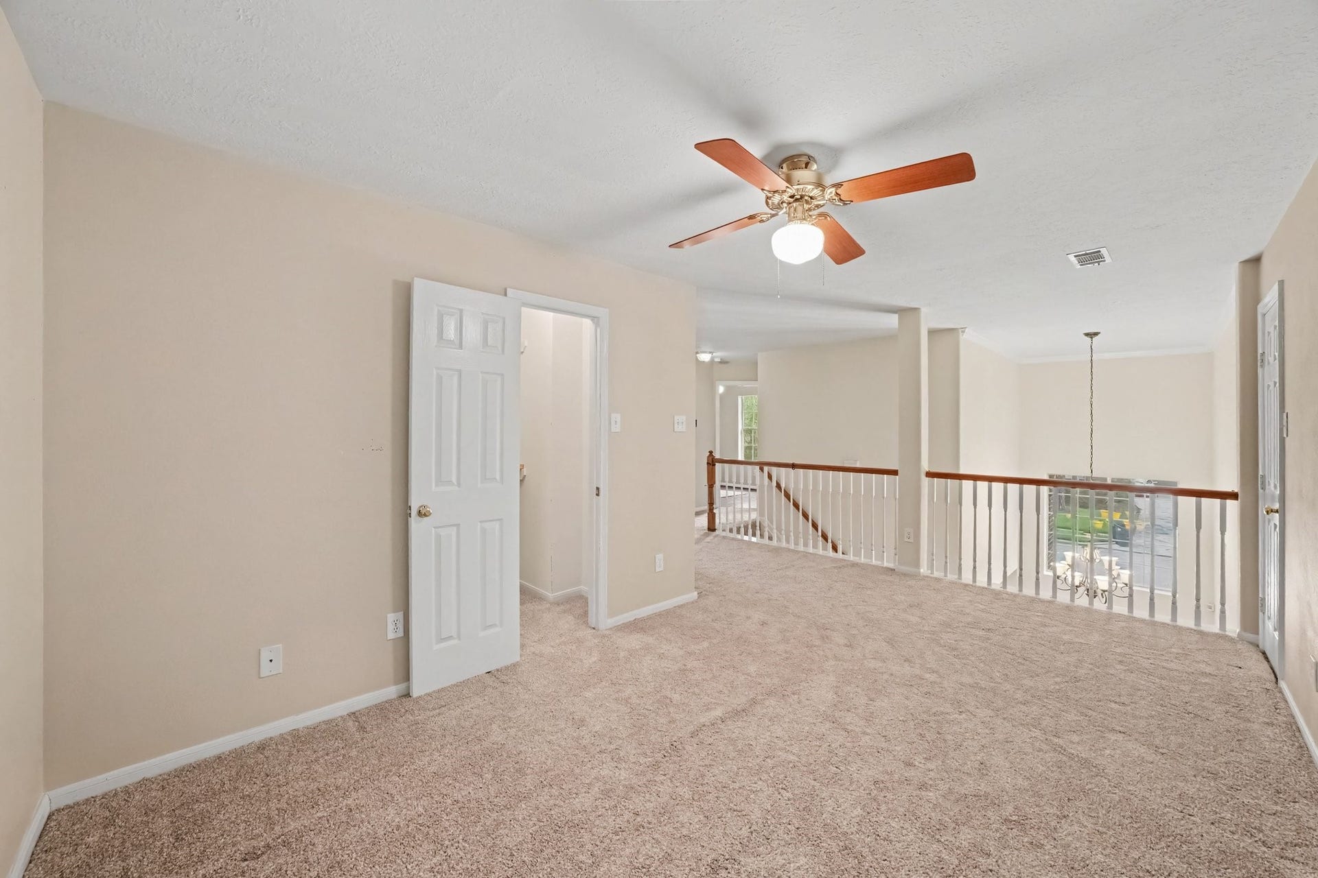17510 Tall Maple Court, Houston, TX 77095 A second view of the upstairs game room highlights its open design overlooking the two-story entry below. The upstairs landing features beautiful wood railing with white spindles, creating an airy feel and an easy connection to the surrounding bedrooms.