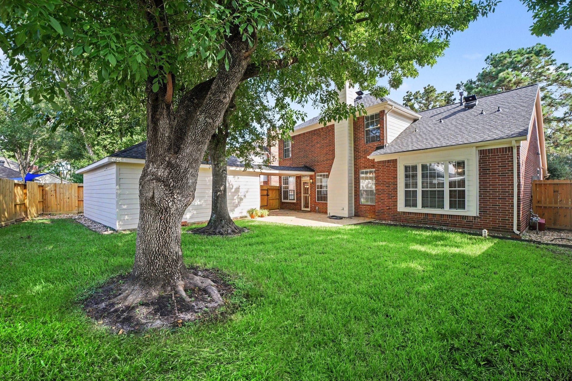 17510 Tall Maple Court, Houston, TX 77095 The backyard offers a beautiful setting with lush green grass, mature shade trees, and plenty of room for outdoor activities. A patio provides space for grilling or relaxing, while the detached two-car garage and fully fenced yard complete this inviting outdoor space.