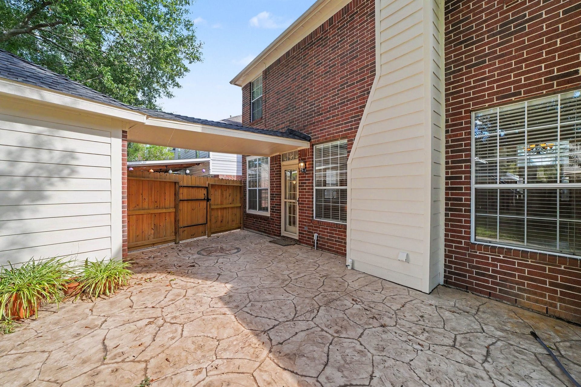 17510 Tall Maple Court, Houston, TX 77095 The extended stamped concrete patio offers plenty of room for outdoor dining, grilling, and entertaining. A covered breezeway connects the home to the detached two-car garage, providing convenient sheltered access between the two.