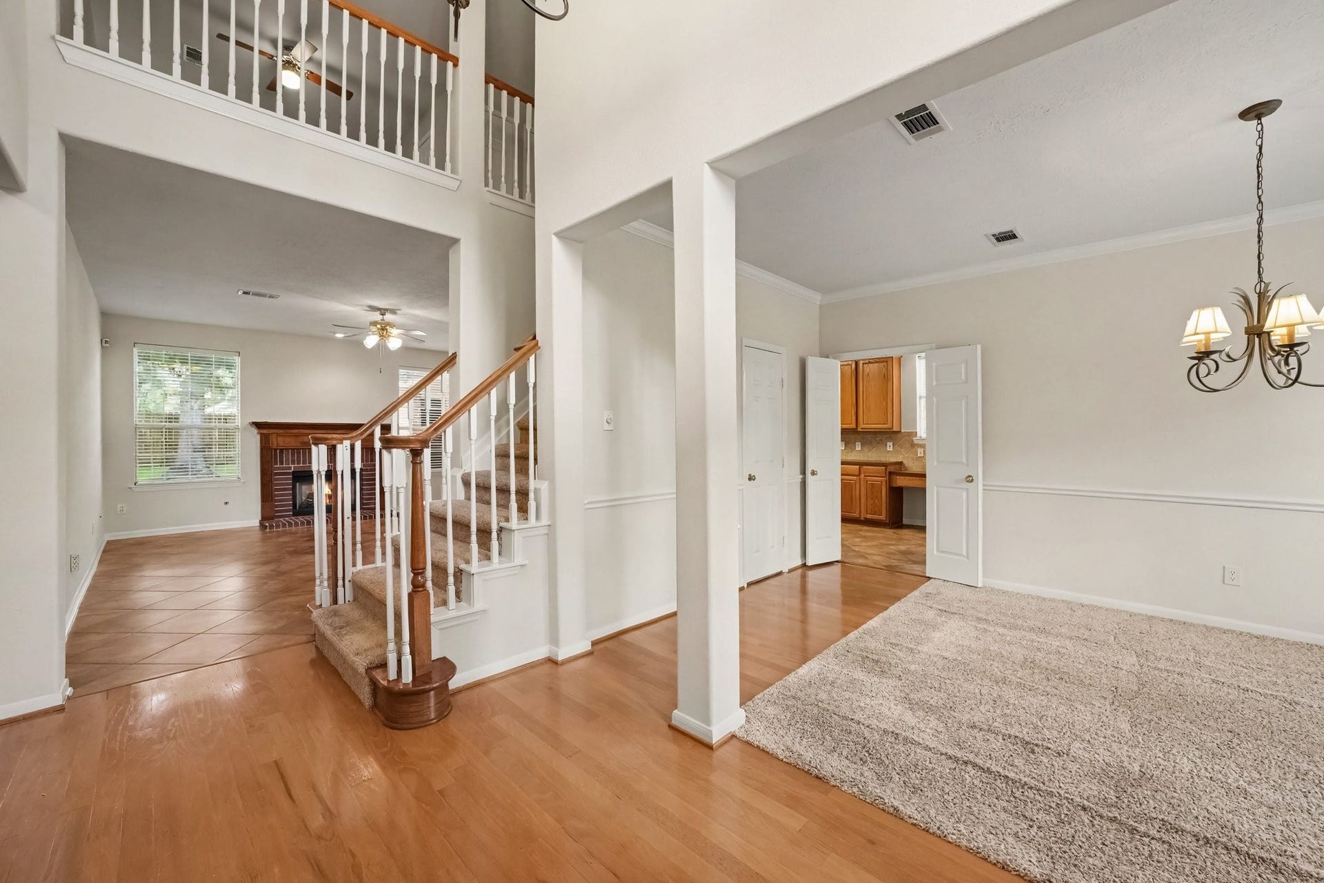 17510 Tall Maple Court, Houston, TX 77095 A welcoming two-story entry with soaring ceilings and an open view of the staircase, living room with fireplace, and formal dining room, with convenient access to the kitchen.
