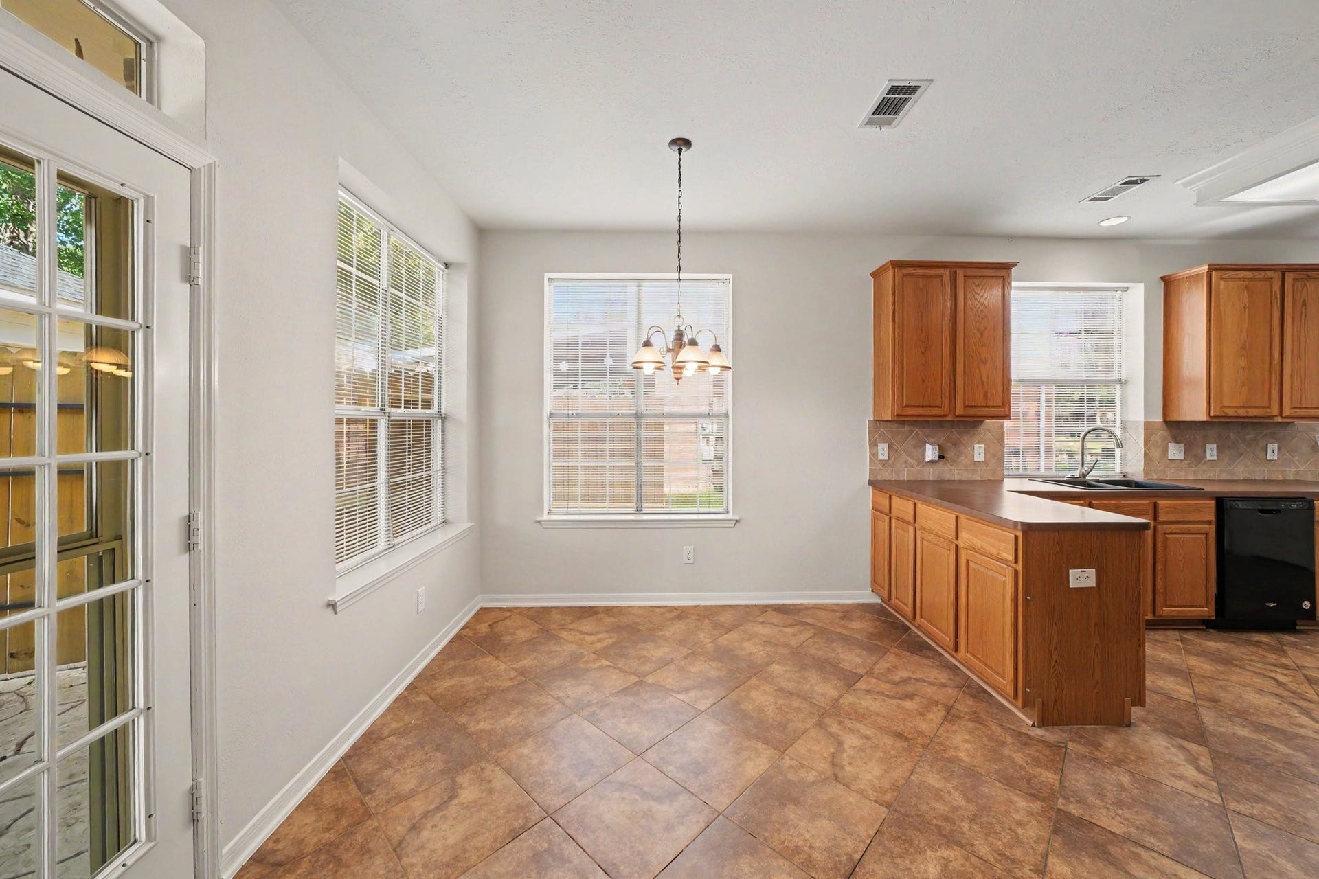 17510 Tall Maple Court, Houston, TX 77095 The bright and inviting breakfast area is surrounded by windows that fill the space with natural light. Conveniently located just off the kitchen, it offers the perfect setting for casual dining, with easy access to the backyard through the glass-paneled door.