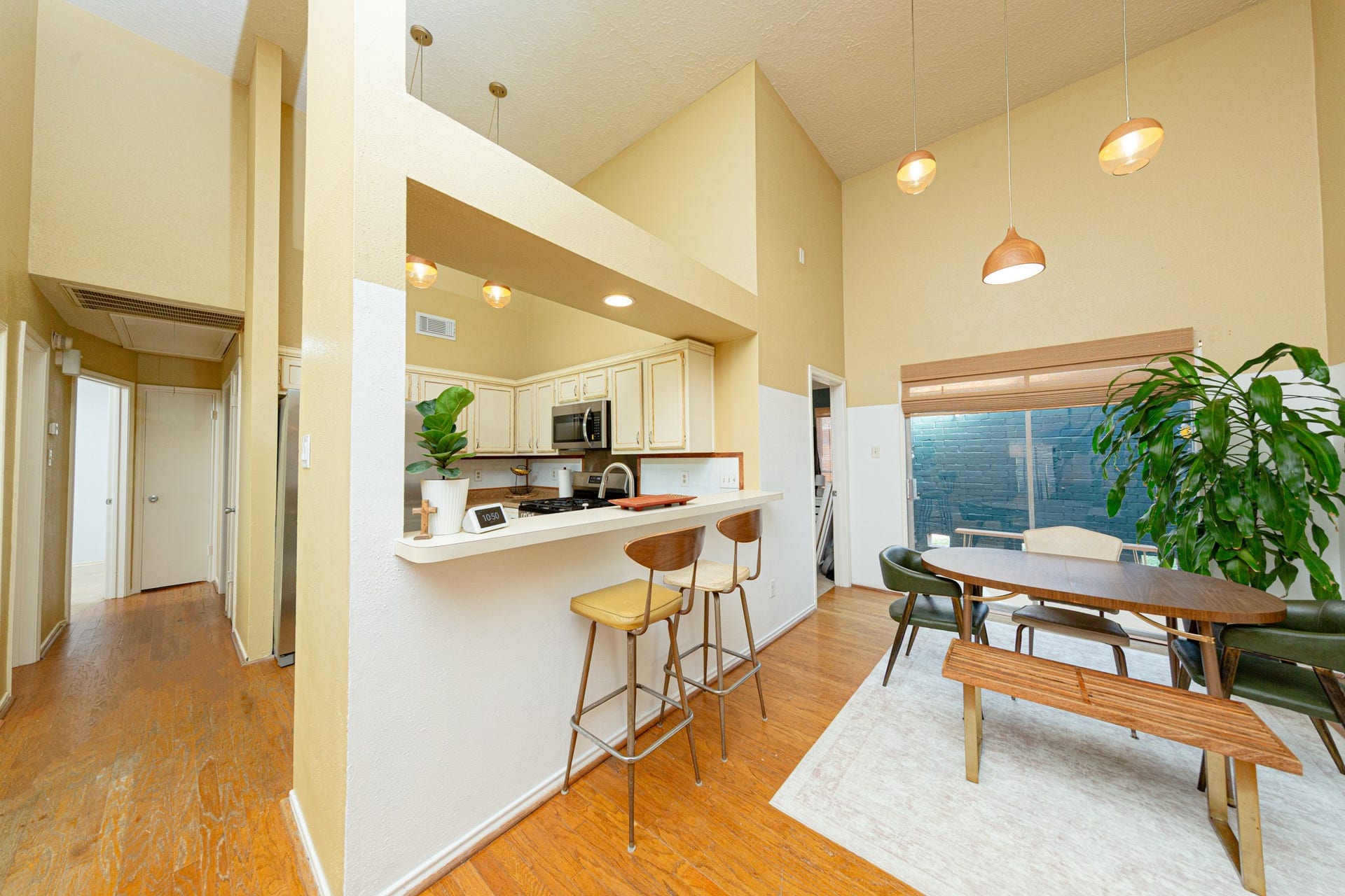 2107 Foundary Drive, Katy, TX 77493 Enjoy casual dining beneath stylish pendant lighting, with convenient access to the kitchen and views of the backyard through sliding glass doors.