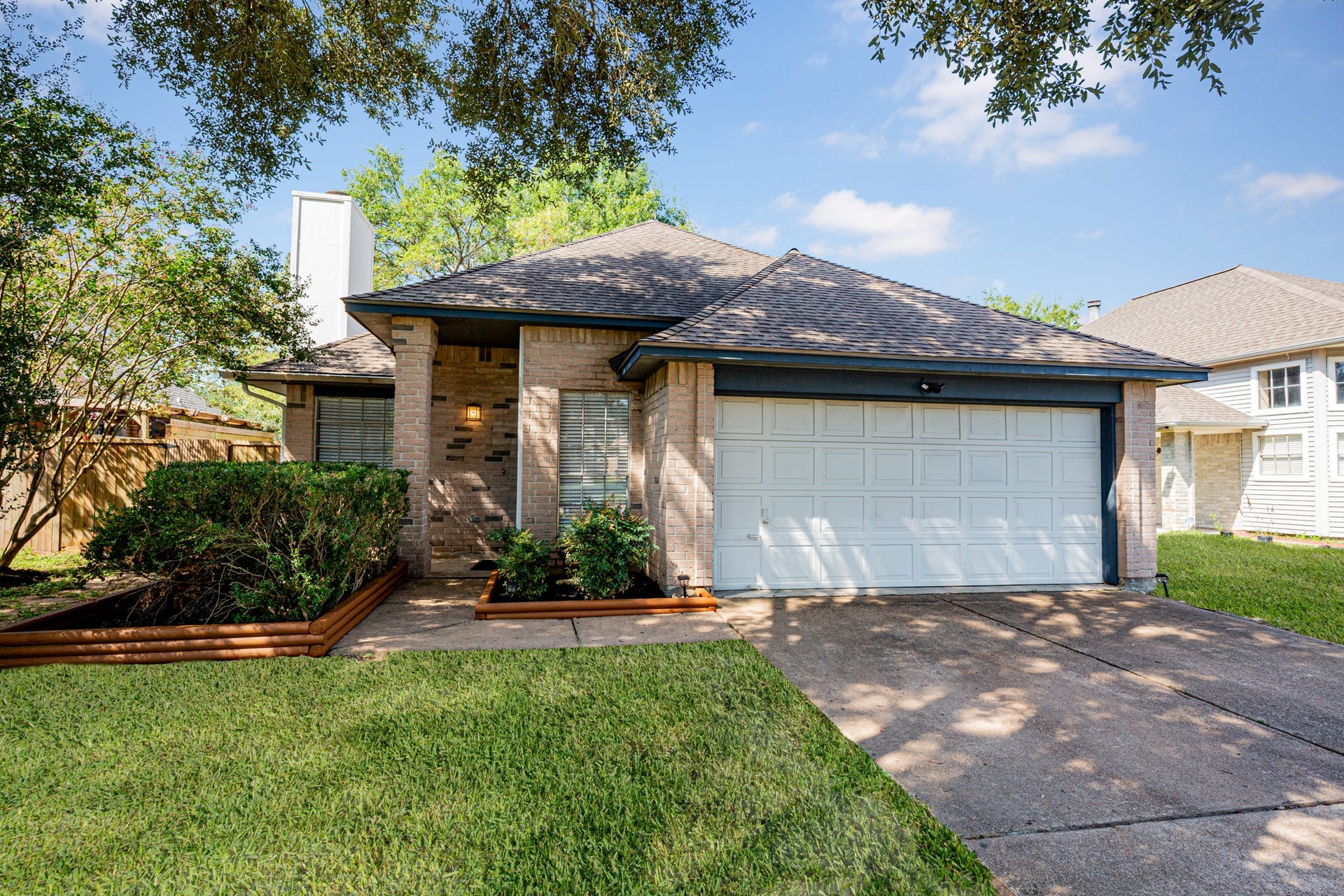 2107 Foundary Drive, Katy, TX 77493 A closer look at the inviting covered front entry, surrounded by manicured hedges, attractive brickwork, and landscaped flower beds.