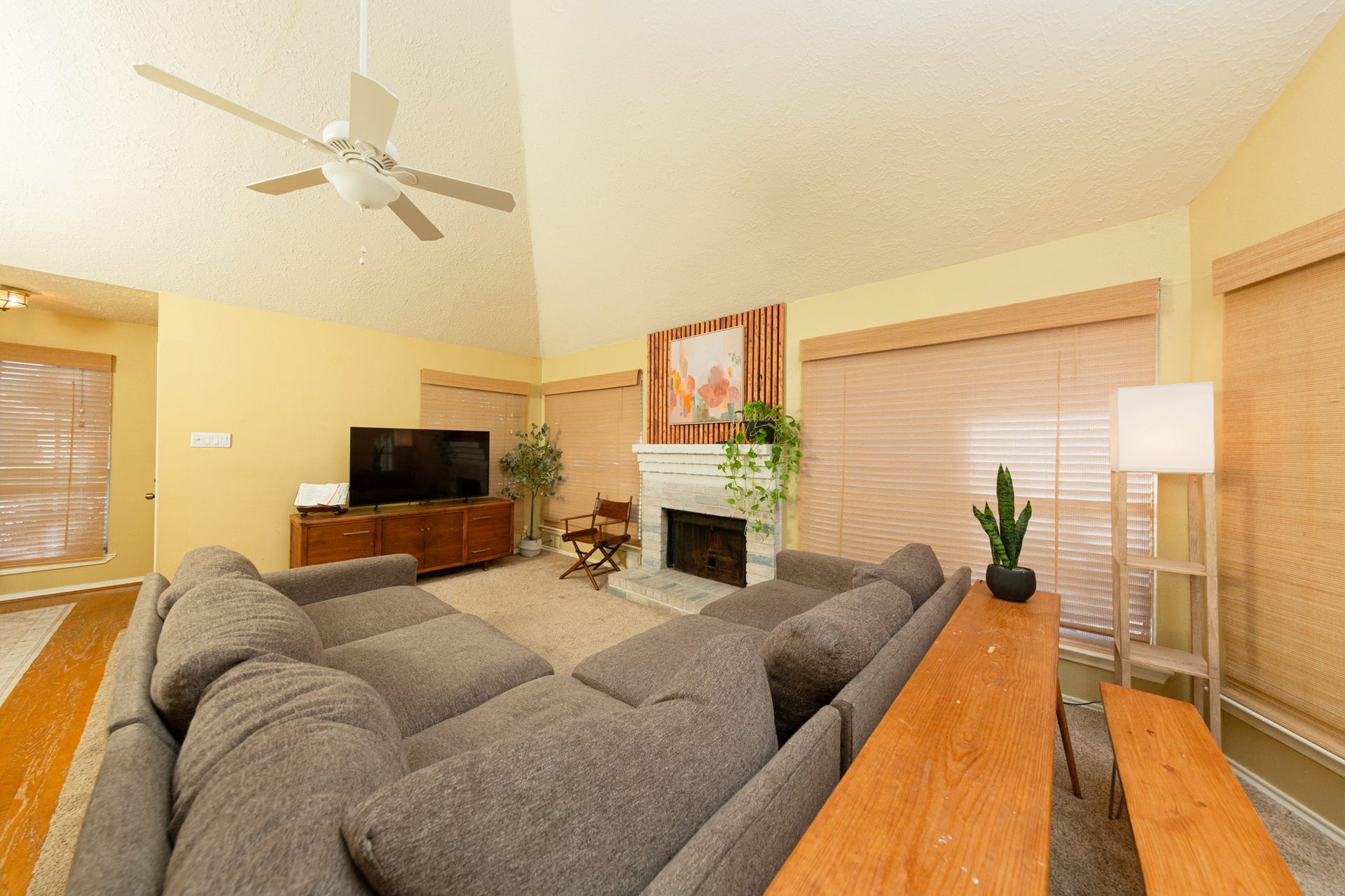 2107 Foundary Drive, Katy, TX 77493 The spacious family room features vaulted ceilings, abundant natural light, and a wood-burning fireplace that serves as a cozy focal point.