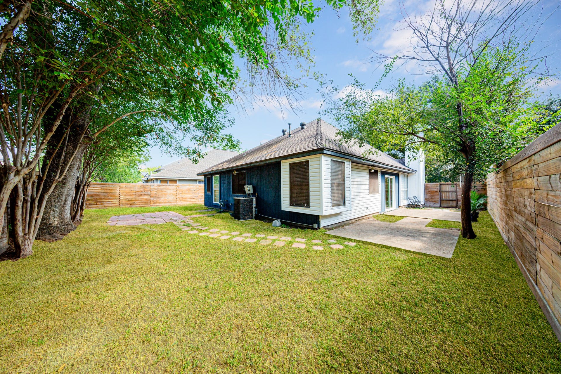 2107 Foundary Drive, Katy, TX 77493 A spacious backyard offers room for outdoor gatherings, gardening, or play, with established trees providing natural shade.