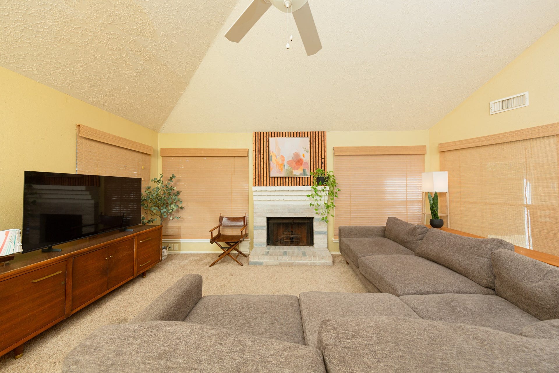 2107 Foundary Drive, Katy, TX 77493 The spacious family room features vaulted ceilings, abundant natural light, and a wood-burning fireplace that serves as a cozy focal point.