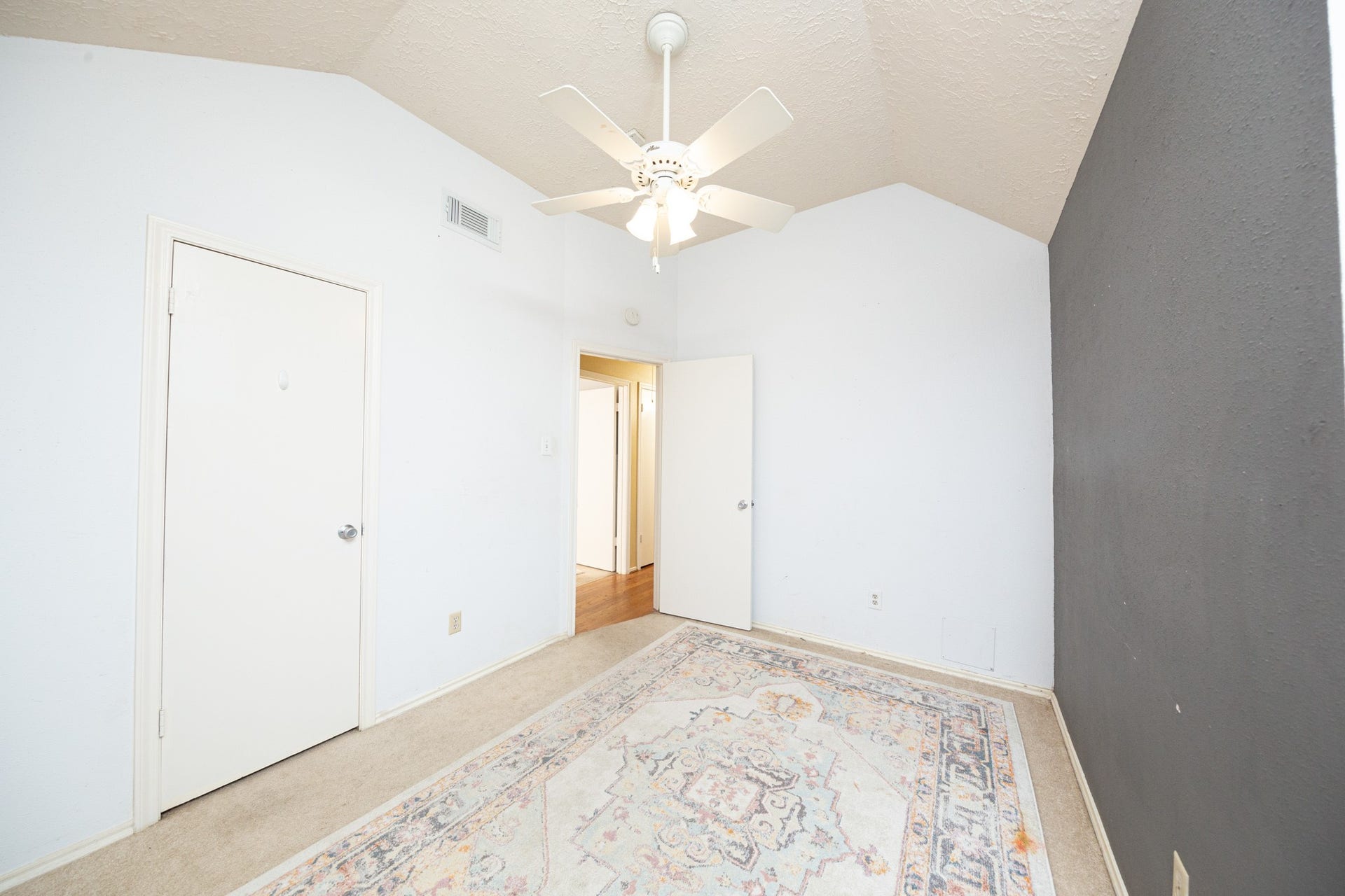2107 Foundary Drive, Katy, TX 77493 This comfortable secondary bedroom features soft neutral tones, chair rail detailing, and a window that brings in natural light.