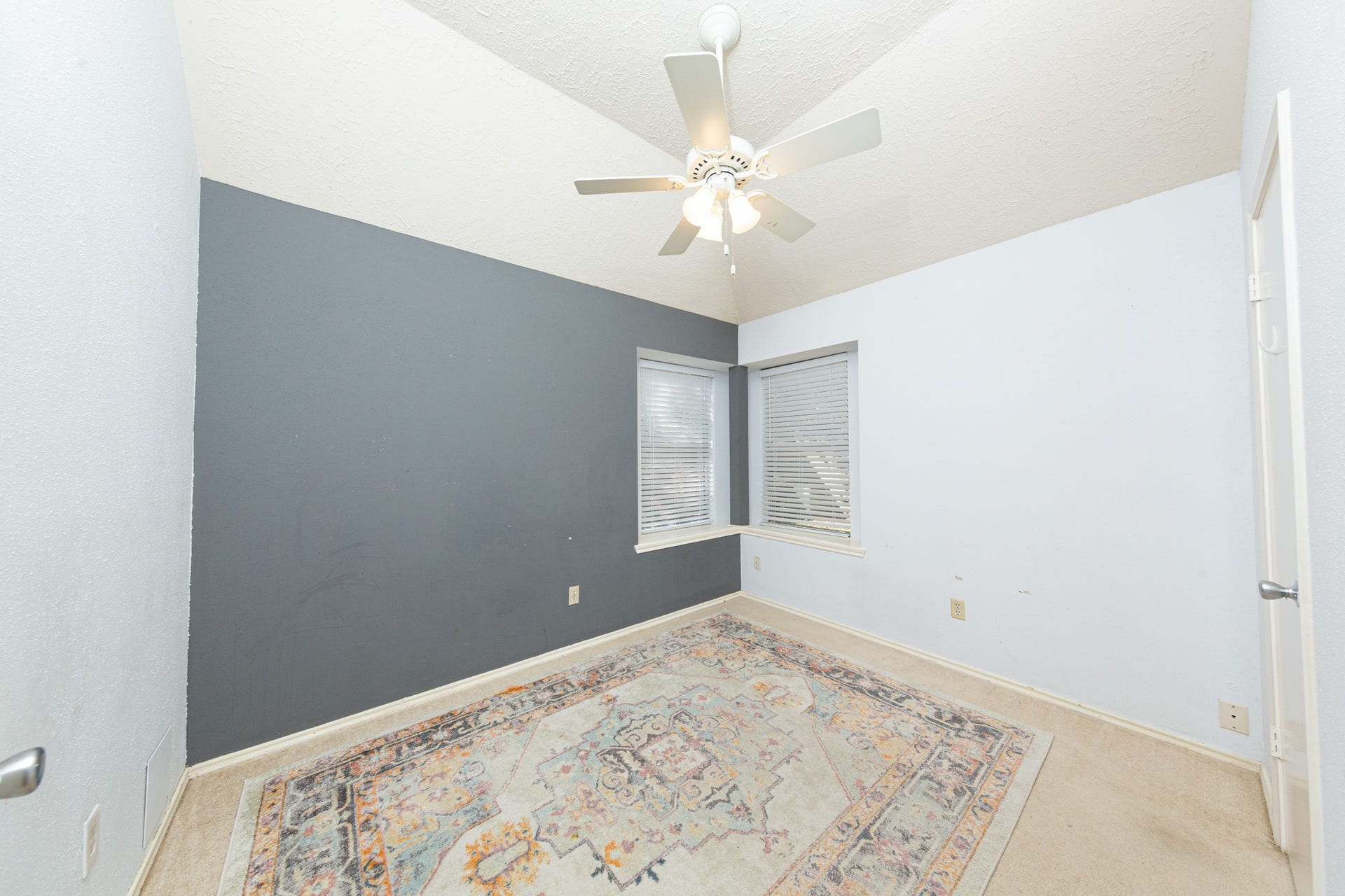 2107 Foundary Drive, Katy, TX 77493 This comfortable secondary bedroom features soft neutral tones, chair rail detailing, and a window that brings in natural light.
