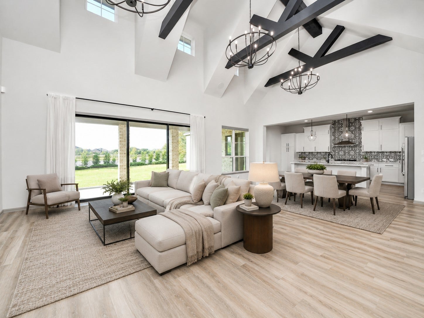 1423 Hackberry Heights Drive, Richmond, TX 77406 Spacious open-concept living area with high ceilings, elegant dark wood beams, and abundant natural light.