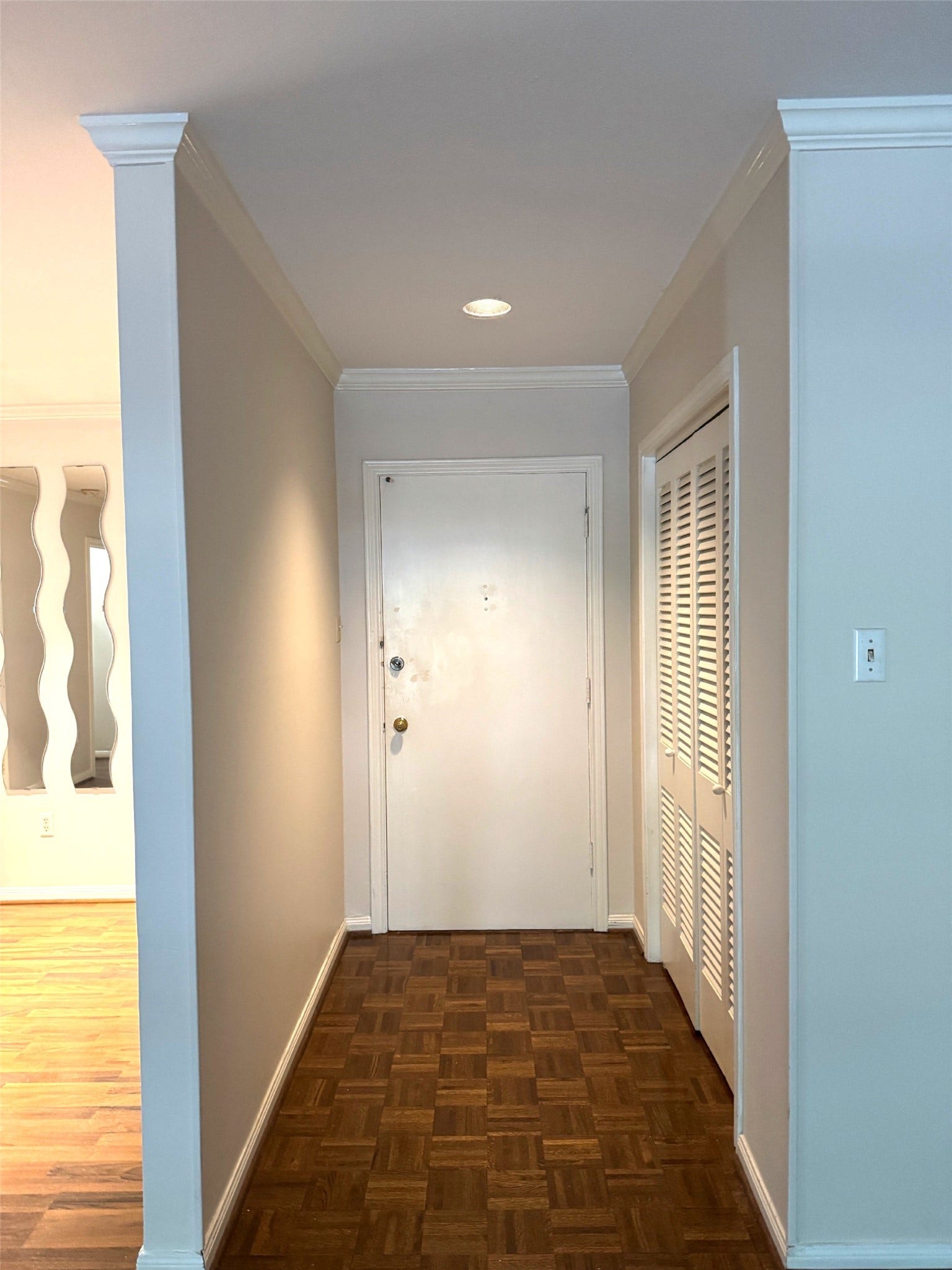 2600 Bellefontaine Street, #A18, Houston, TX 77025 Entry hall with retro parquet flooring and large storage closet with bifold doors.