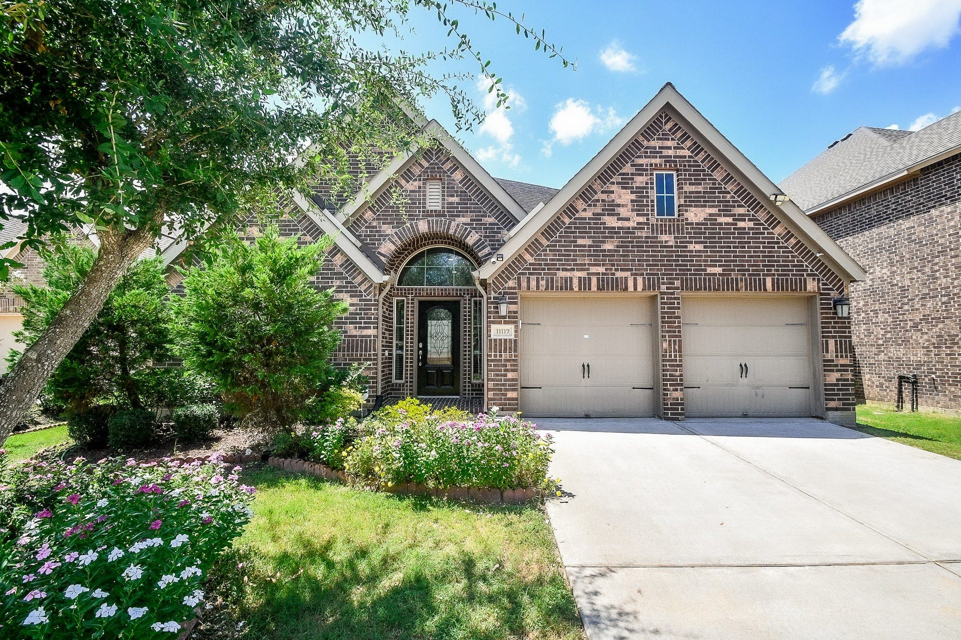 Charming brick home with a welcoming arched entryway, two-car garage, and well-maintained landscaping. Ideal for buyers seeking a blend of elegance and comfort.
