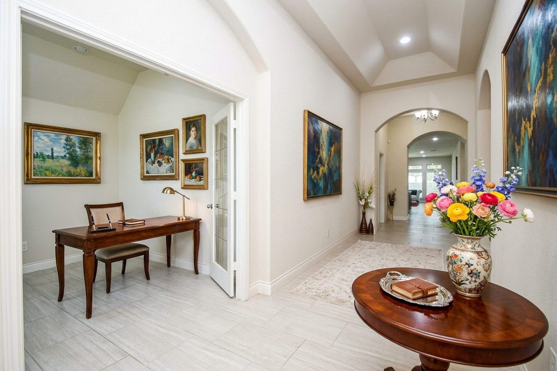 Elegant entryway with a high ceiling, featuring a beautifully lit hallway adorned with artwork. A cozy study or office space is on the side, complemented by classic wooden furniture and tasteful decor.  AI designed
