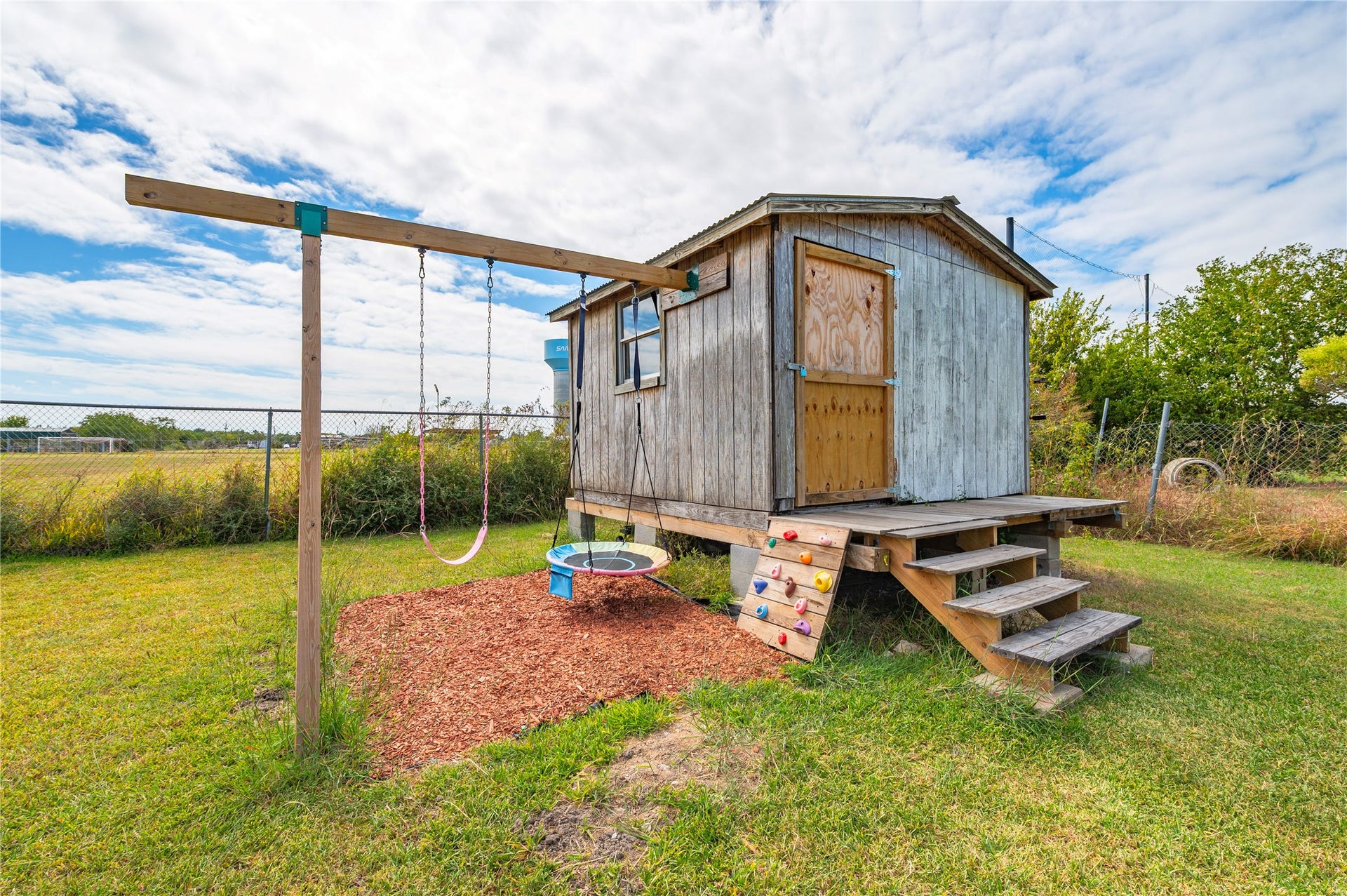 2337 Avenue D, San Leon, TX 77539 Storage shed and kids swing at the back of the property.