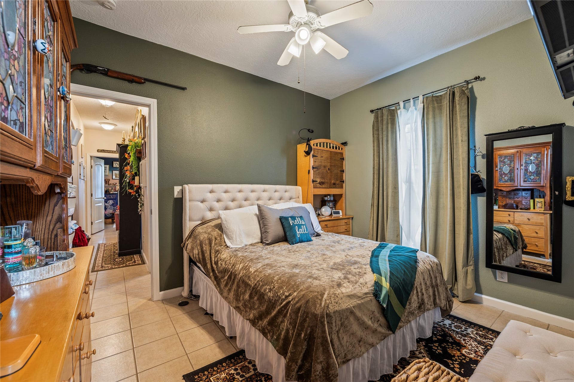 2337 Avenue D, San Leon, TX 77539 Spacious primary bedroom with tile flooring and ceiling fan fixture.