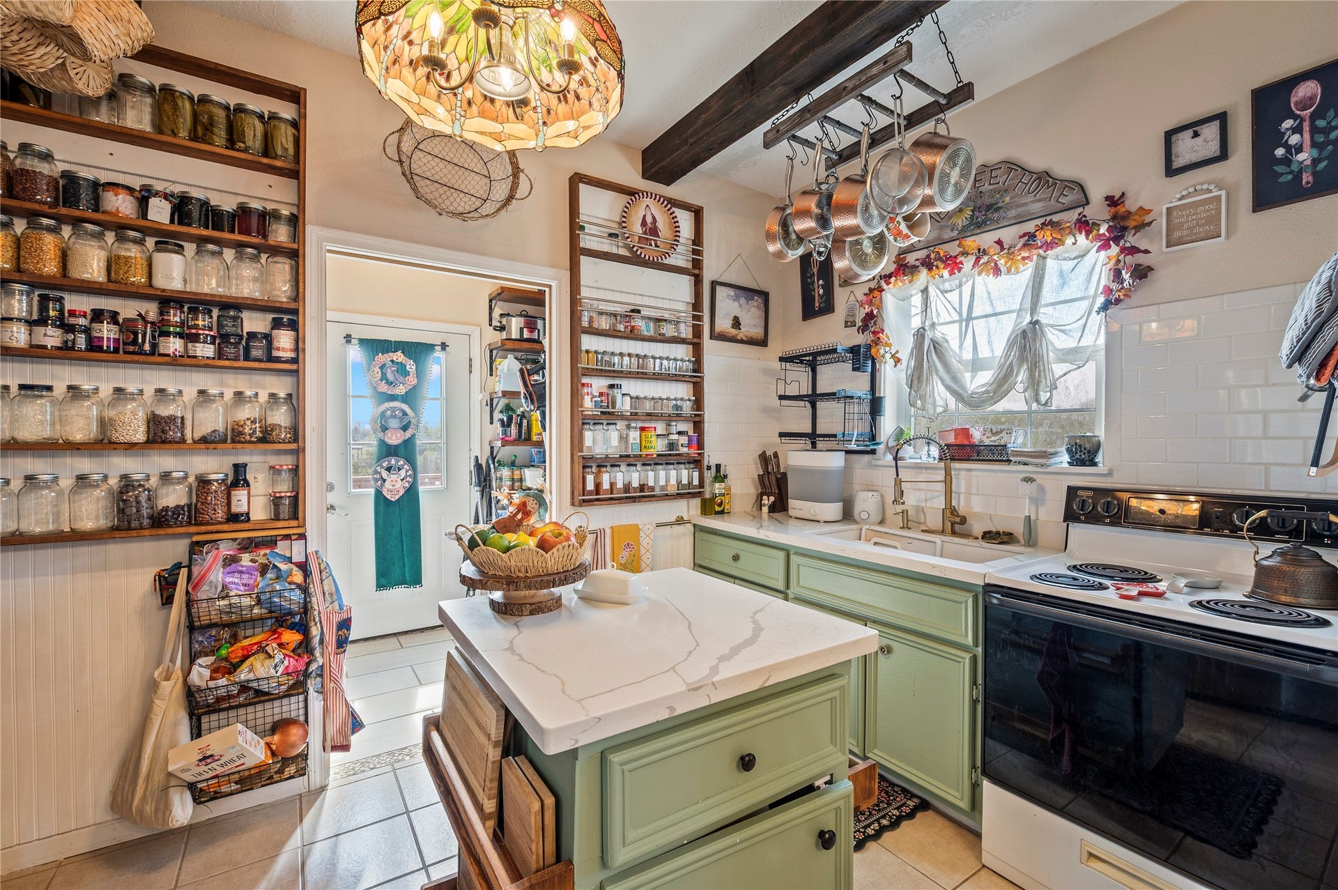 2337 Avenue D, San Leon, TX 77539 Custom island kitchen with upscale light fixtures, tile flooring, and more custom wall fixtures.