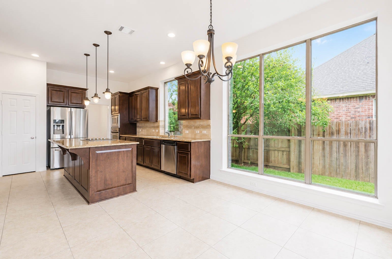 3814 Bluffstone Court, Sugar Land, TX 77479 Light filled breakfast area surrounded by oversized windows creates an inviting everyday dining space beside the kitchen.
