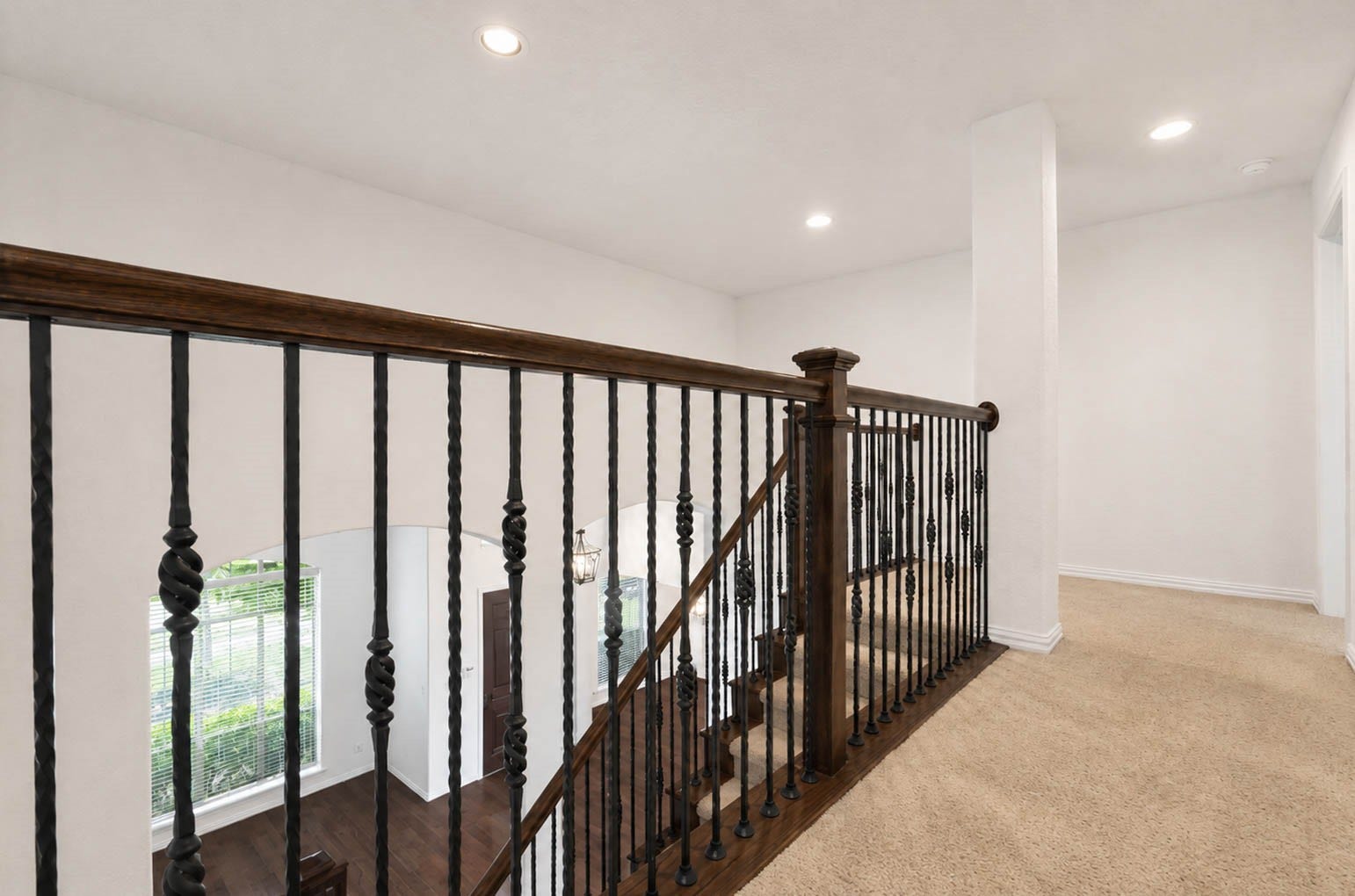 3814 Bluffstone Court, Sugar Land, TX 77479 Open upstairs landing with wrought iron railing and additional flexible space for a study nook, lounge or play area.