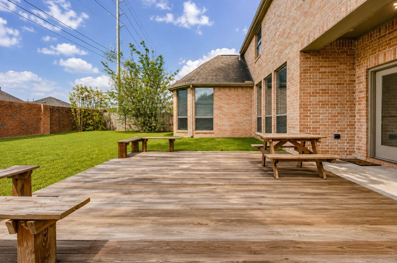 3814 Bluffstone Court, Sugar Land, TX 77479 Large wood deck extends the home's living space outdoors with room for multiple seating and entertaining areas.
