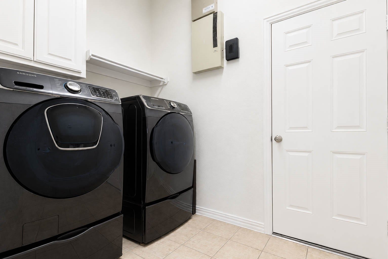 3814 Bluffstone Court, Sugar Land, TX 77479 Laundry room with cabinetry, shelving and space for full-size washer and dryer.