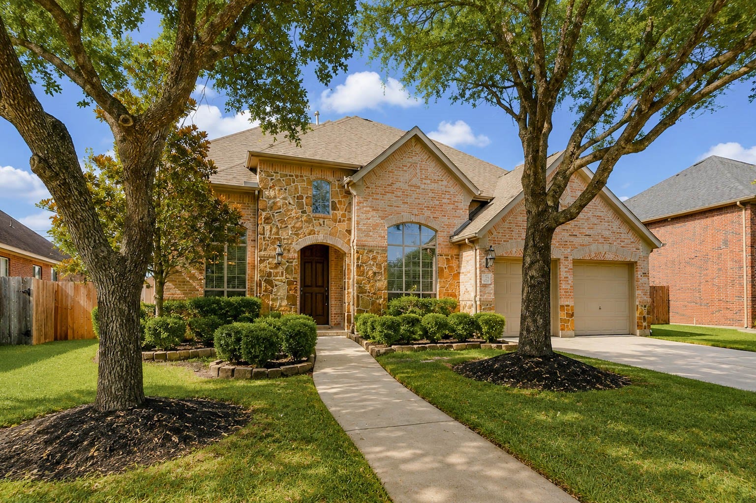 3814 Bluffstone Court, Sugar Land, TX 77479 Welcoming approach framed by mature trees, lush landscaping and a curved walkway leading to the front entry.